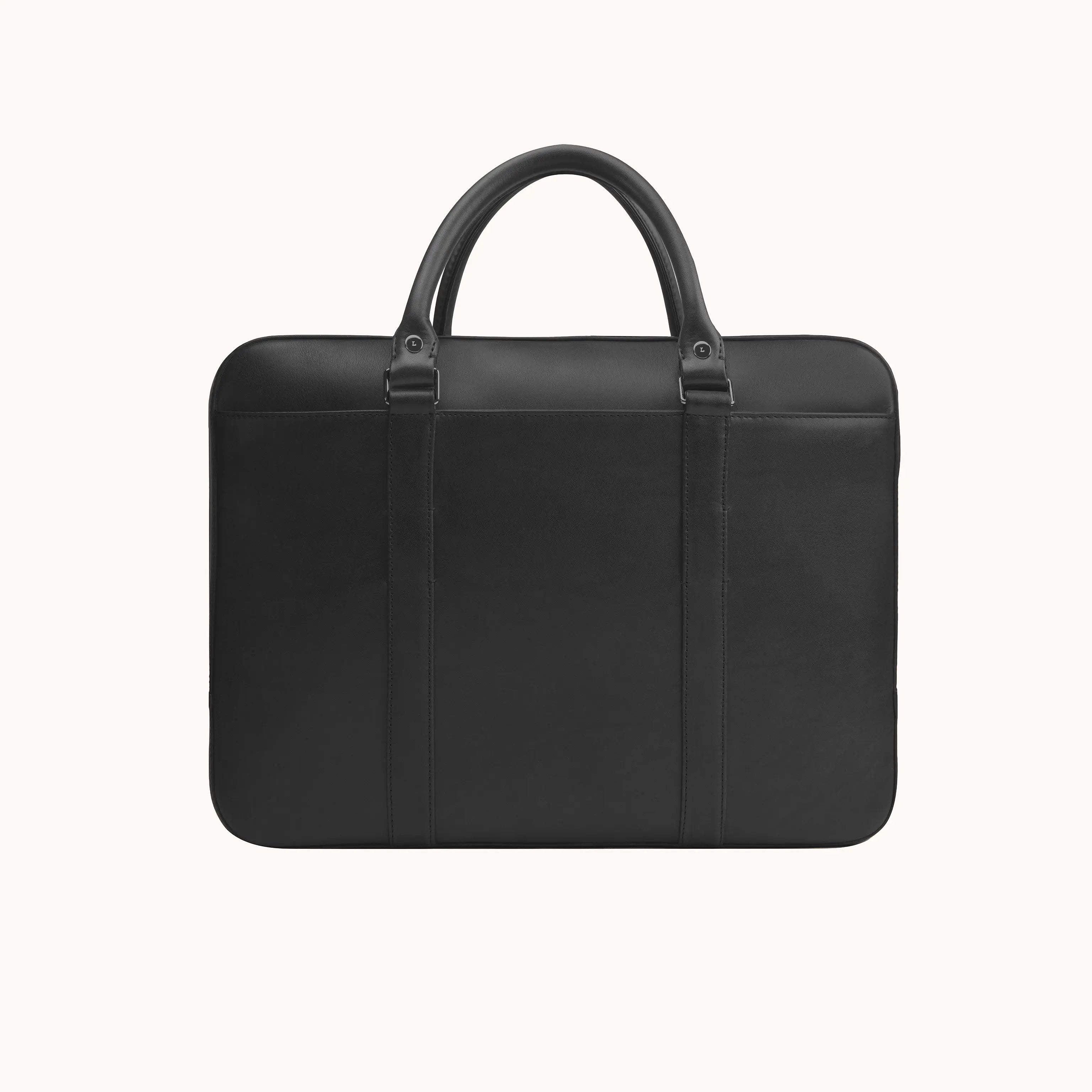 Lunburg Opus Briefcase in Burnt Timber vegetable-tanned Perpetual Leather (from Tempesti), back view showing clean panel construction, folded leather handles, and 316L stainless steel studs.