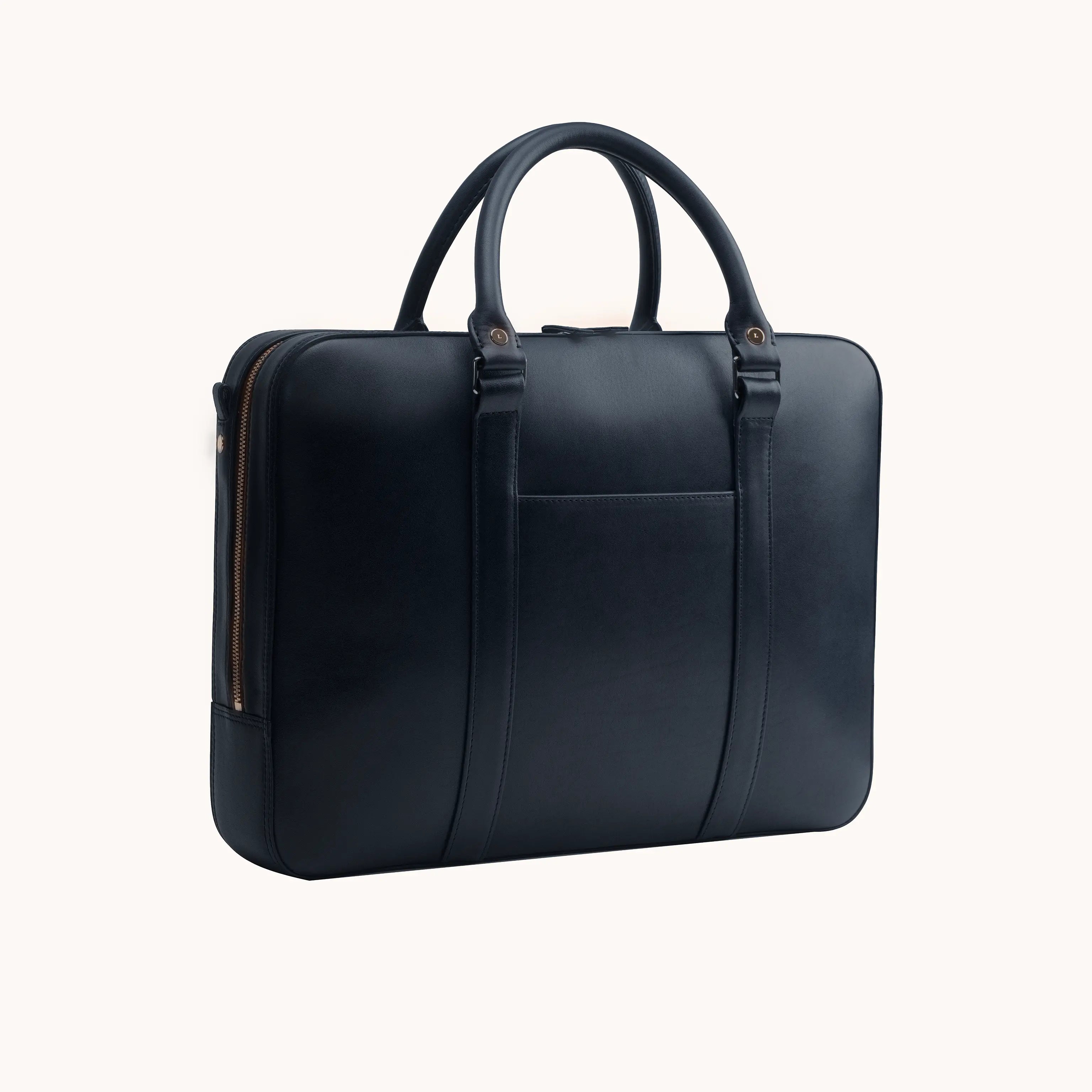 Lunburg Opus Briefcase in Nocturnal Sapphire vegetable-tanned Perpetual Leather (from Tempesti), three-quarter view showing folded edge construction, exterior slip pocket, folded leather handles, and 316L stainless steel hardware.