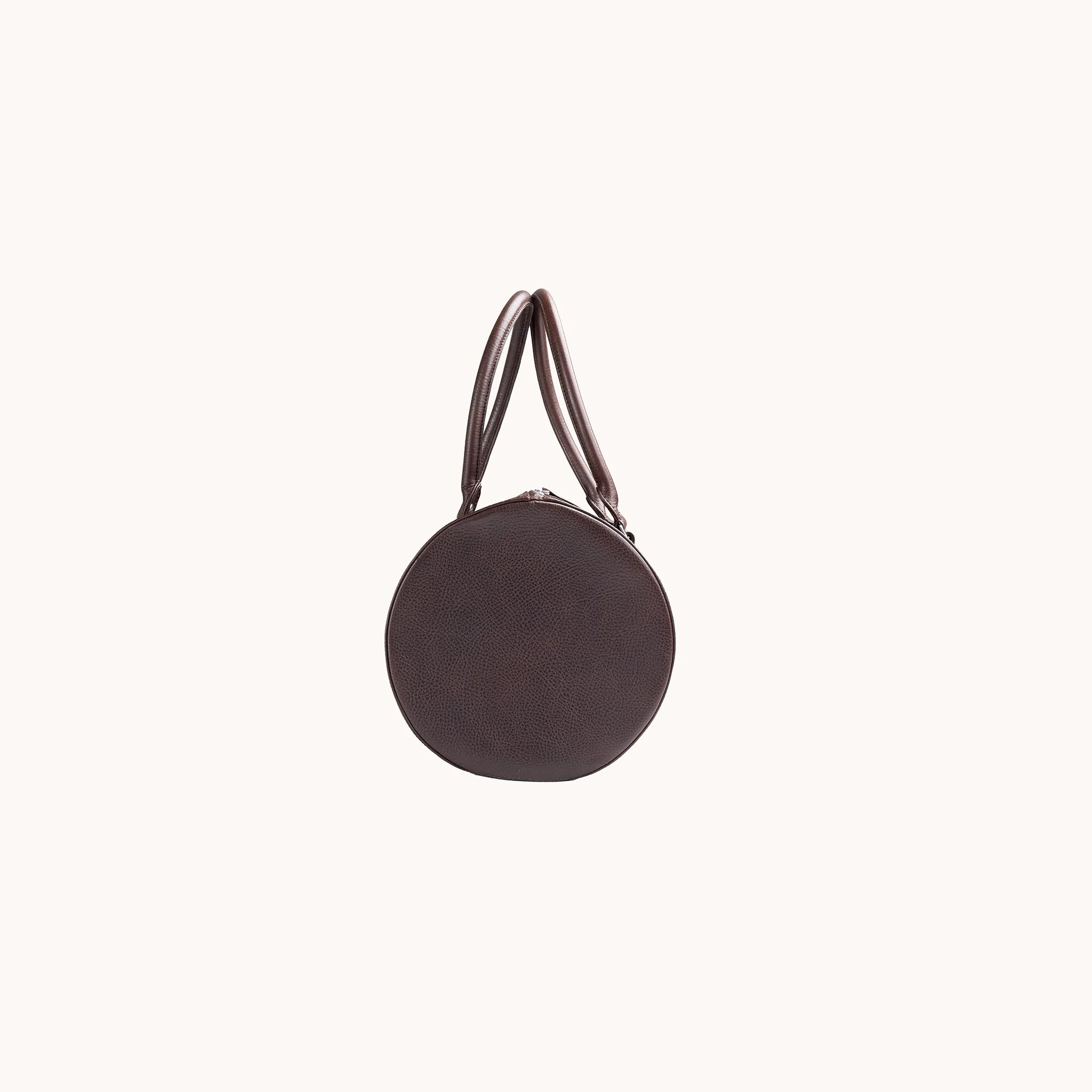 Lunburg Estate Club Bag in tumbled Deep Mahogany leather, side profile showing volume and handle attachment.