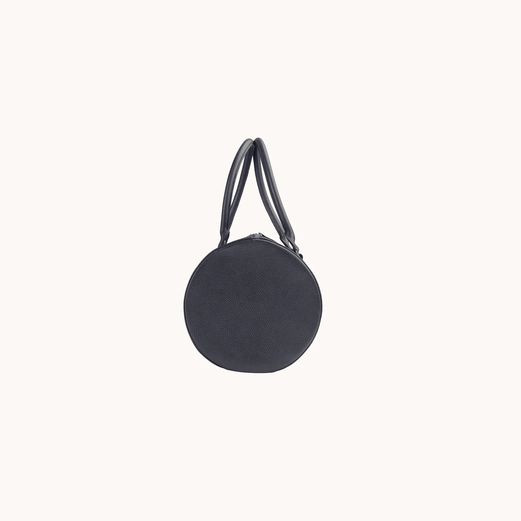 Lunburg Estate Club Bag in tumbled Nocturnal Sapphire leather, side profile showing volume and handle attachment.