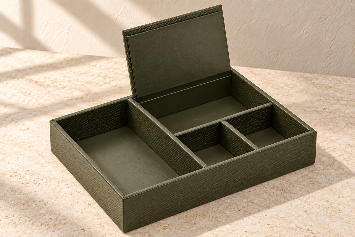 Illustrative covered-compartment valet tray, view 2: raised rear lid reveals fourth compartment; fixed dividers, smooth-looking beds and lid underside visible.