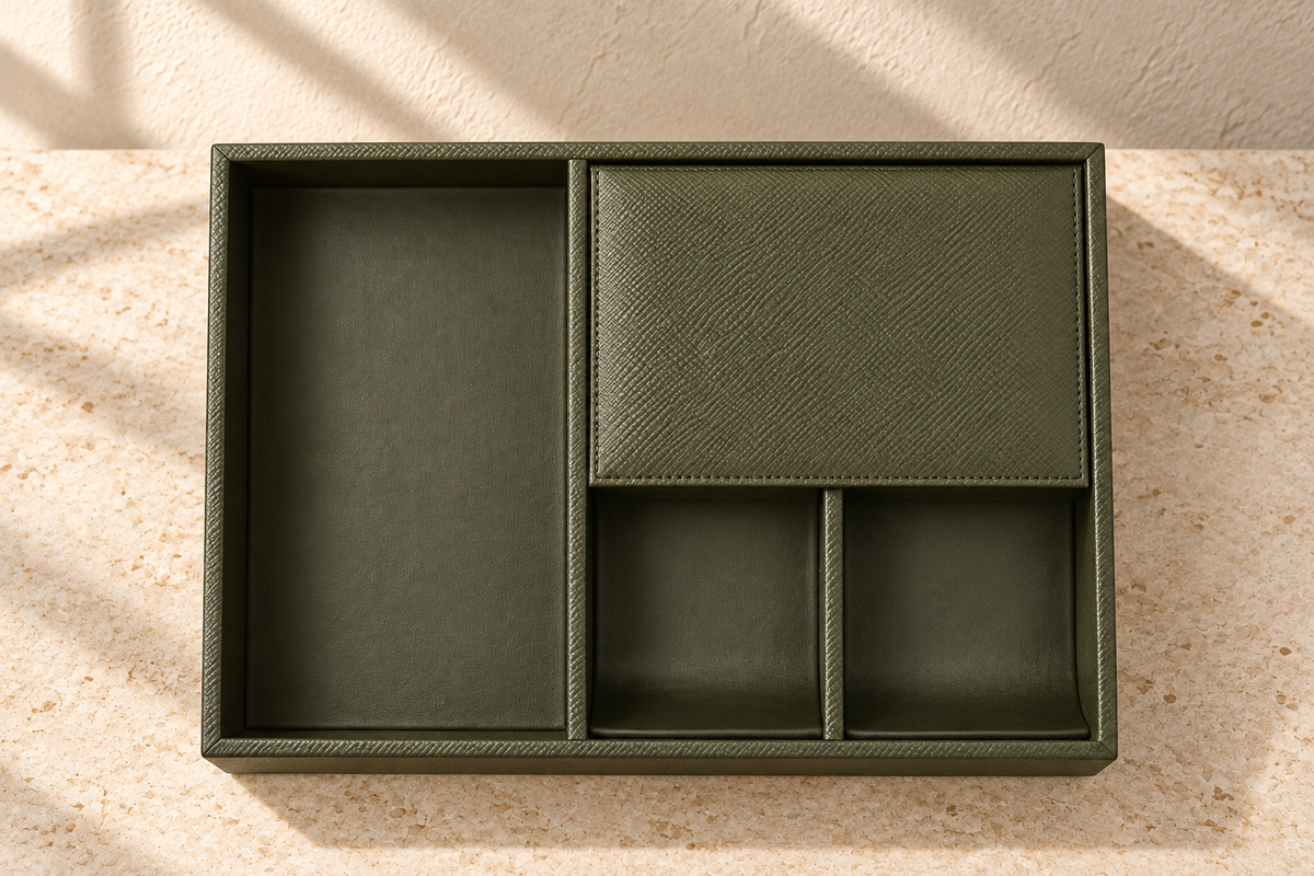 Illustrative covered-compartment valet tray, view 3: top view confirms bay proportions, divider junctions and stitched rectangular lid border. Crossgrain-looking exterior/rim contrasts with smoother recesses.