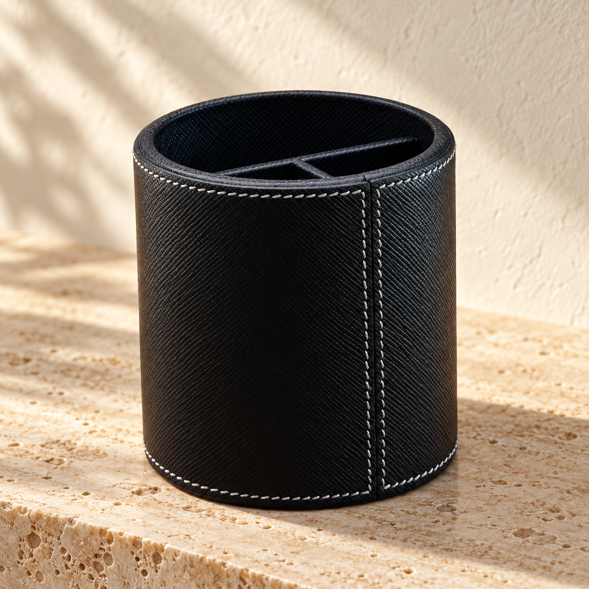 Illustrative divided round pen cup, view 2: rear view shows a vertical stitched join and inner partition edges.