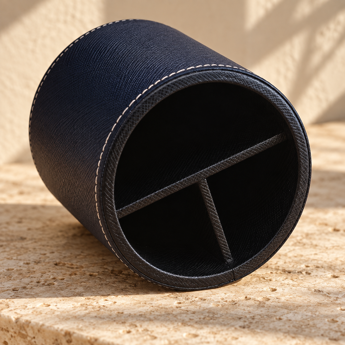 Illustrative divided round pen cup, view 3: tilted interior view shows a long divider with a shorter perpendicular divider forming three areas.