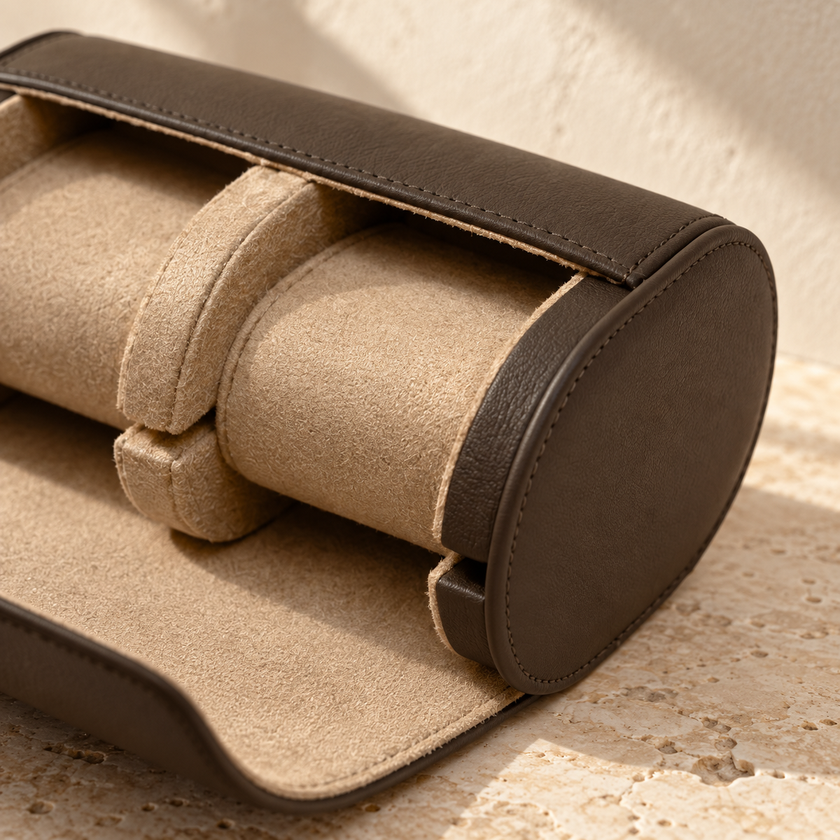 Illustrative divided two-cushion watch roll, view 3: close view shows one cushion, central divider, end support slots and stitched outer edge.