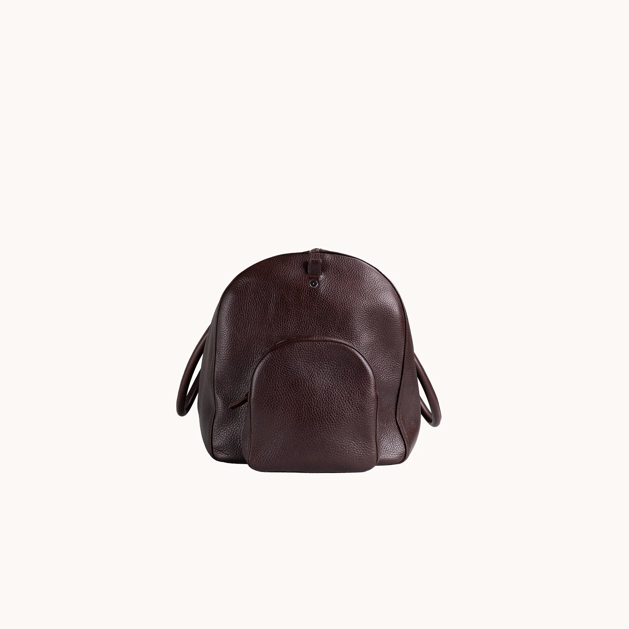 Lunburg Estate Duffle Bag in tumbled Deep Mahogany leather, side profile showing volume and handle attachment.