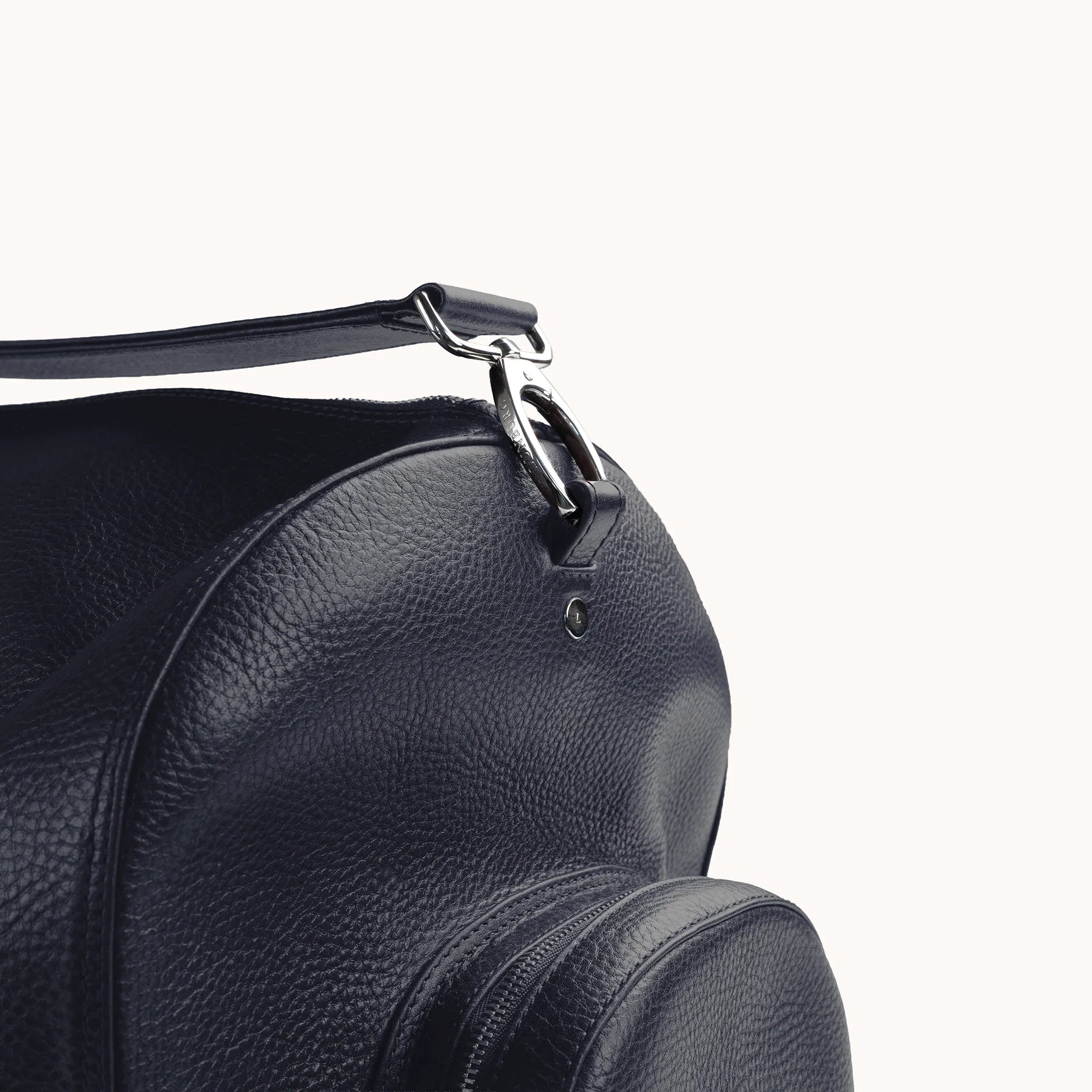 Estate Duffle Bag in Nocturnal Sapphire, strap clasp detail with the L-branded stainless steel stud.