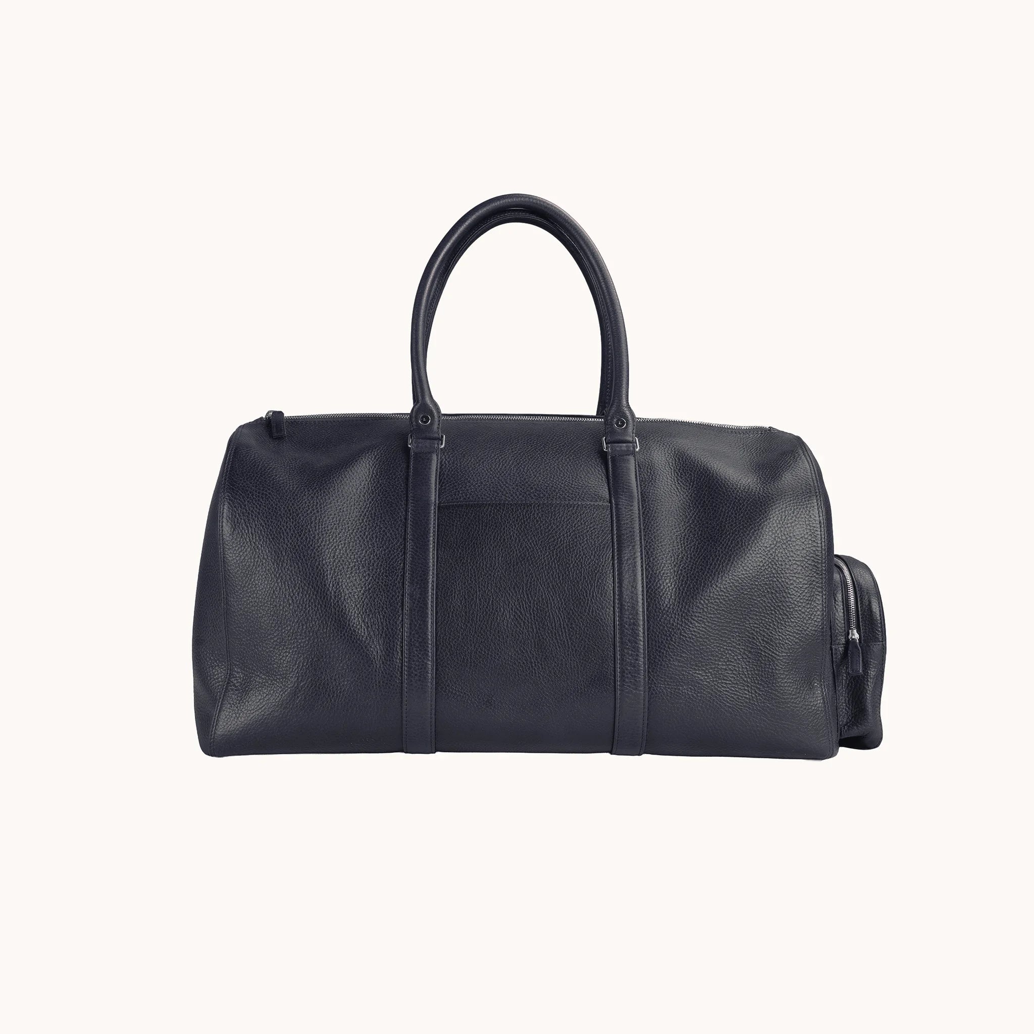 Lunburg Estate Duffle Bag in tumbled Nocturnal Sapphire leather, front view with twin top handles and exterior trim.