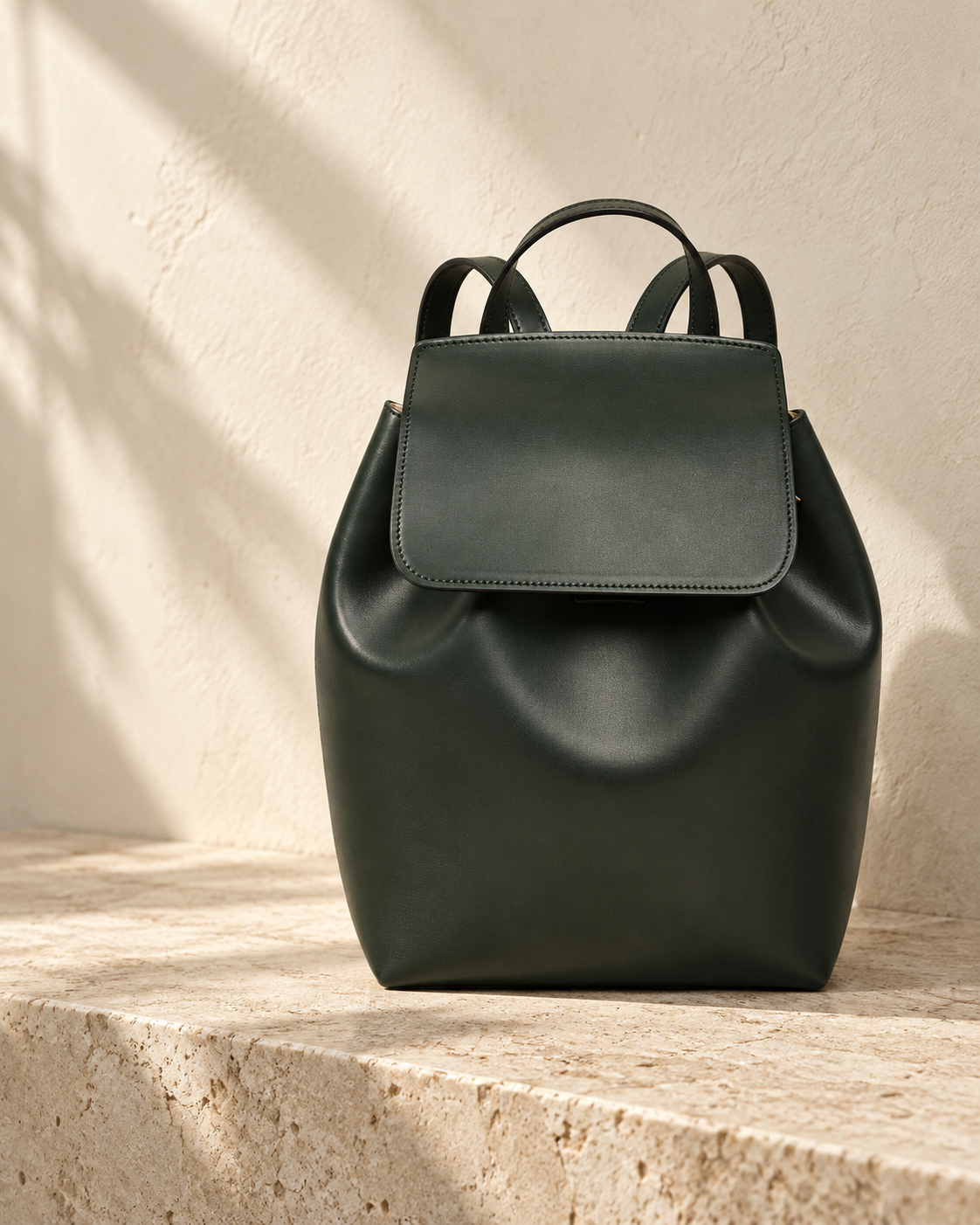 Illustrative gathered flap backpack with a broad rounded-corner flap over a softly gathered upright body.