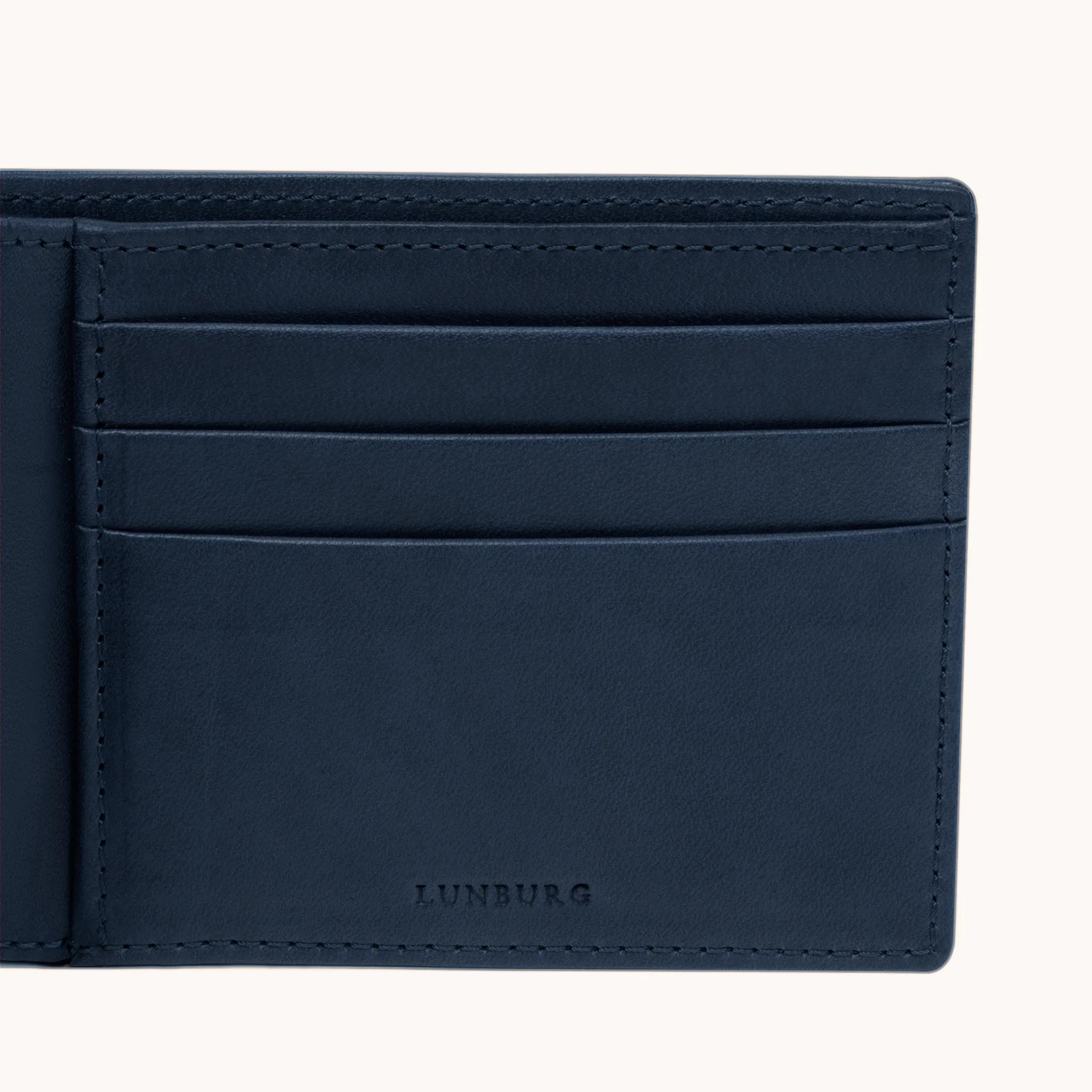 Lunburg Signet Horizontal Bifold in Nocturnal Sapphire, detail view of the interior right panel showing the heat-embossed Lunburg mark beneath card slots in vegetable-tanned Perpetual Leather (from Tempesti) with folded edge construction throughout.