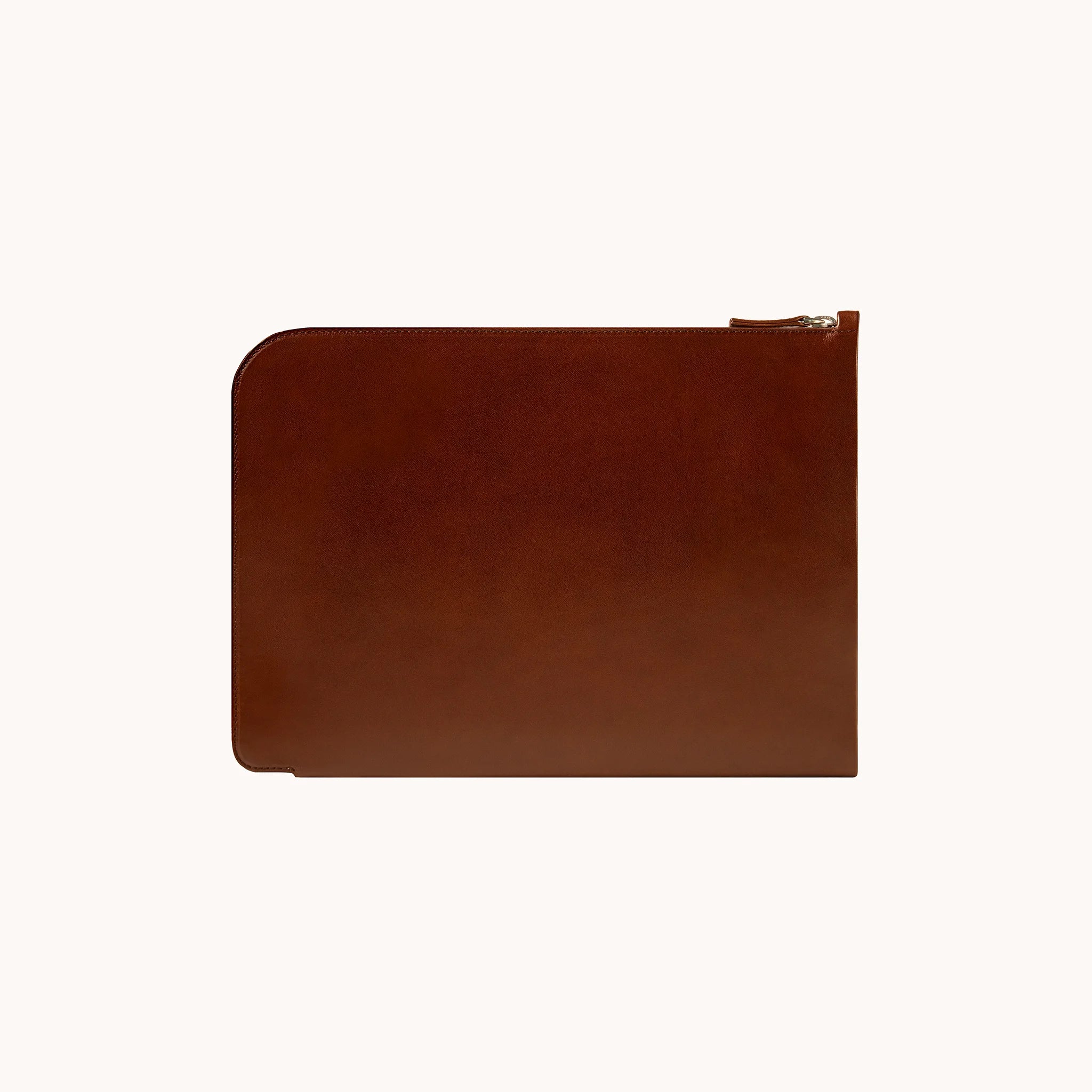 Lunburg Memoir Laptop Sleeve in Deep Mahogany, front view showing the clean face and top YKK Excella zipper with leather pull, in vegetable-tanned Perpetual Leather (from Tempesti) with folded edge construction.