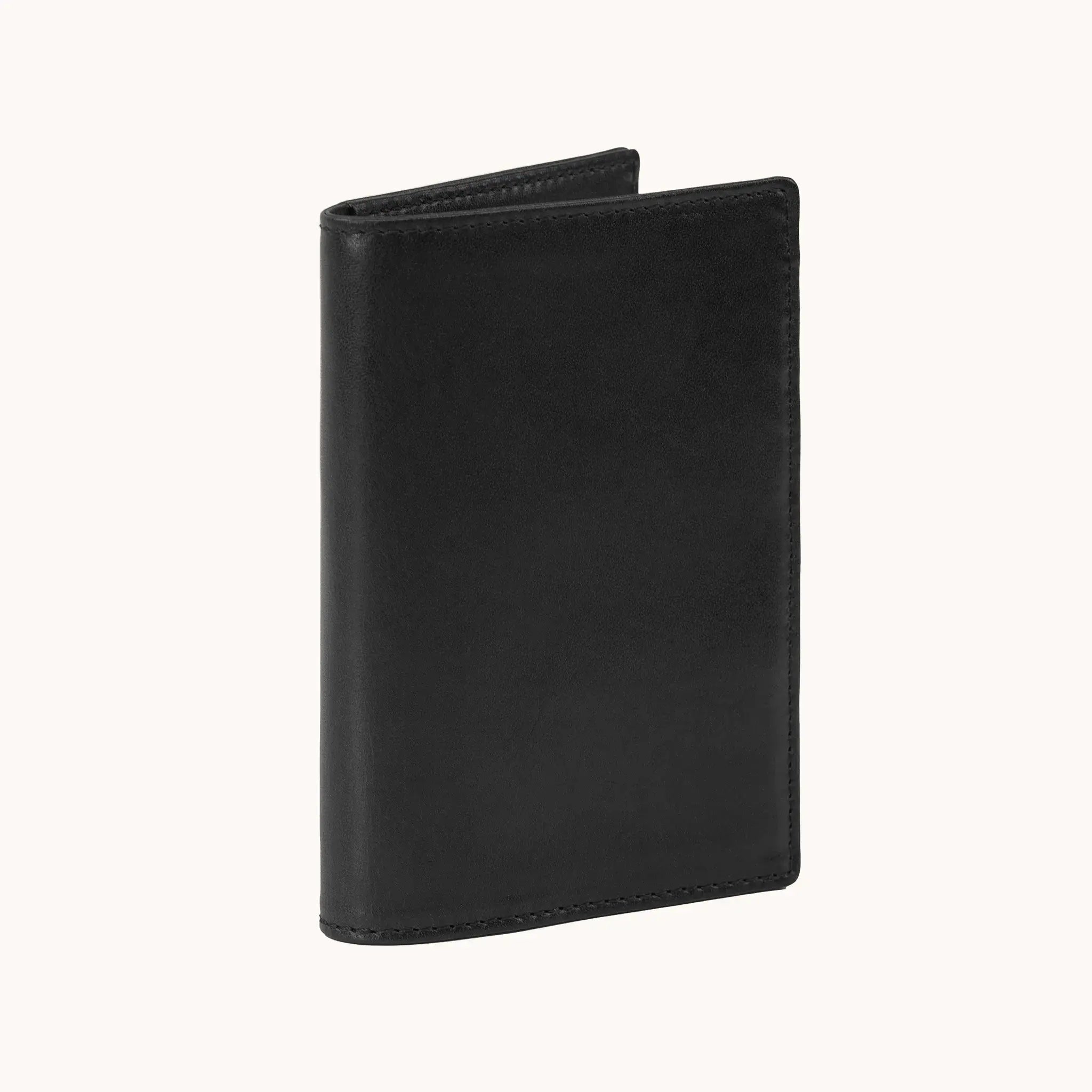 Lunburg Signet Passport Folio in Burnt Timber, three-quarter view slightly open showing the exterior grain, spine, and a glimpse of the interior, in vegetable-tanned Perpetual Leather (from Tempesti) with folded edge construction.
