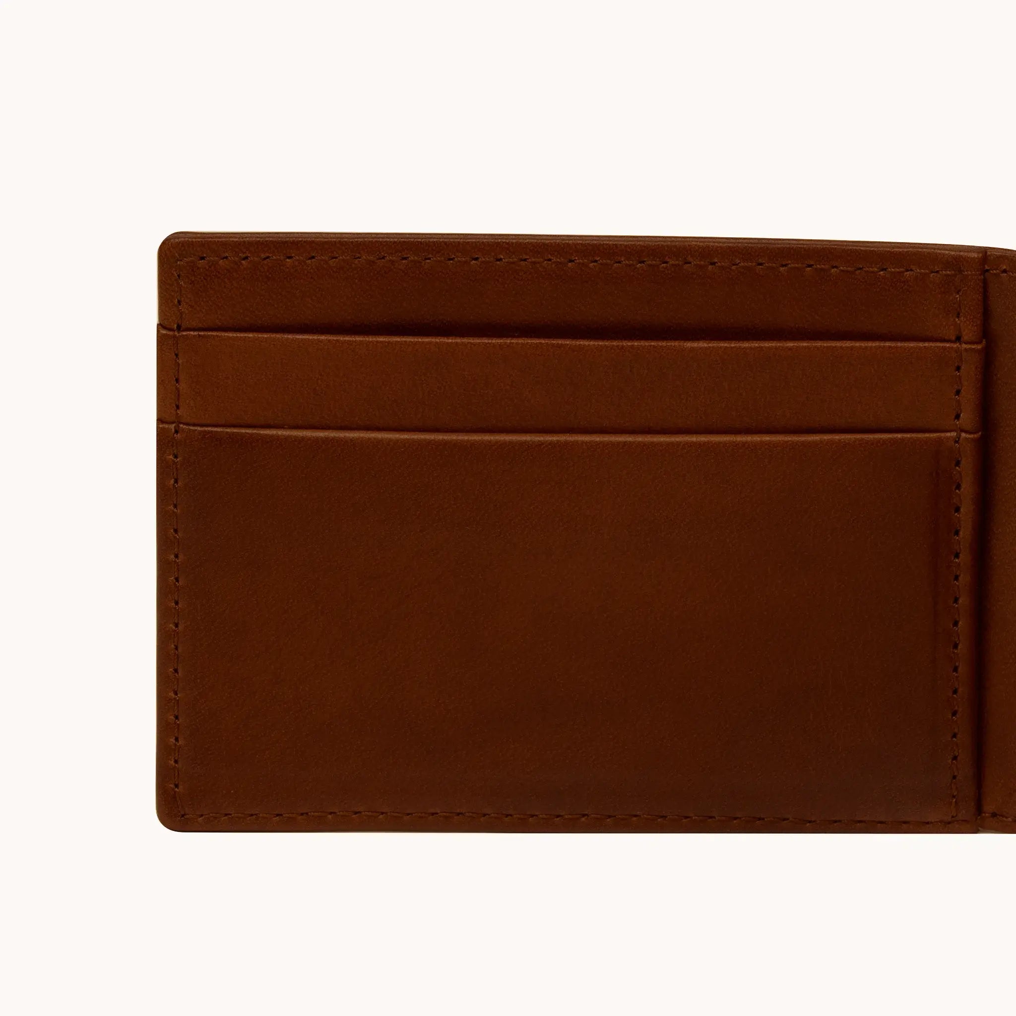 Lunburg Signet Small Horizontal in Deep Mahogany, close-up detail of the interior card slot layering and large open pocket showing the folded edge construction of Rempliage on each pocket edge, in vegetable-tanned Perpetual Leather (from Tempesti).