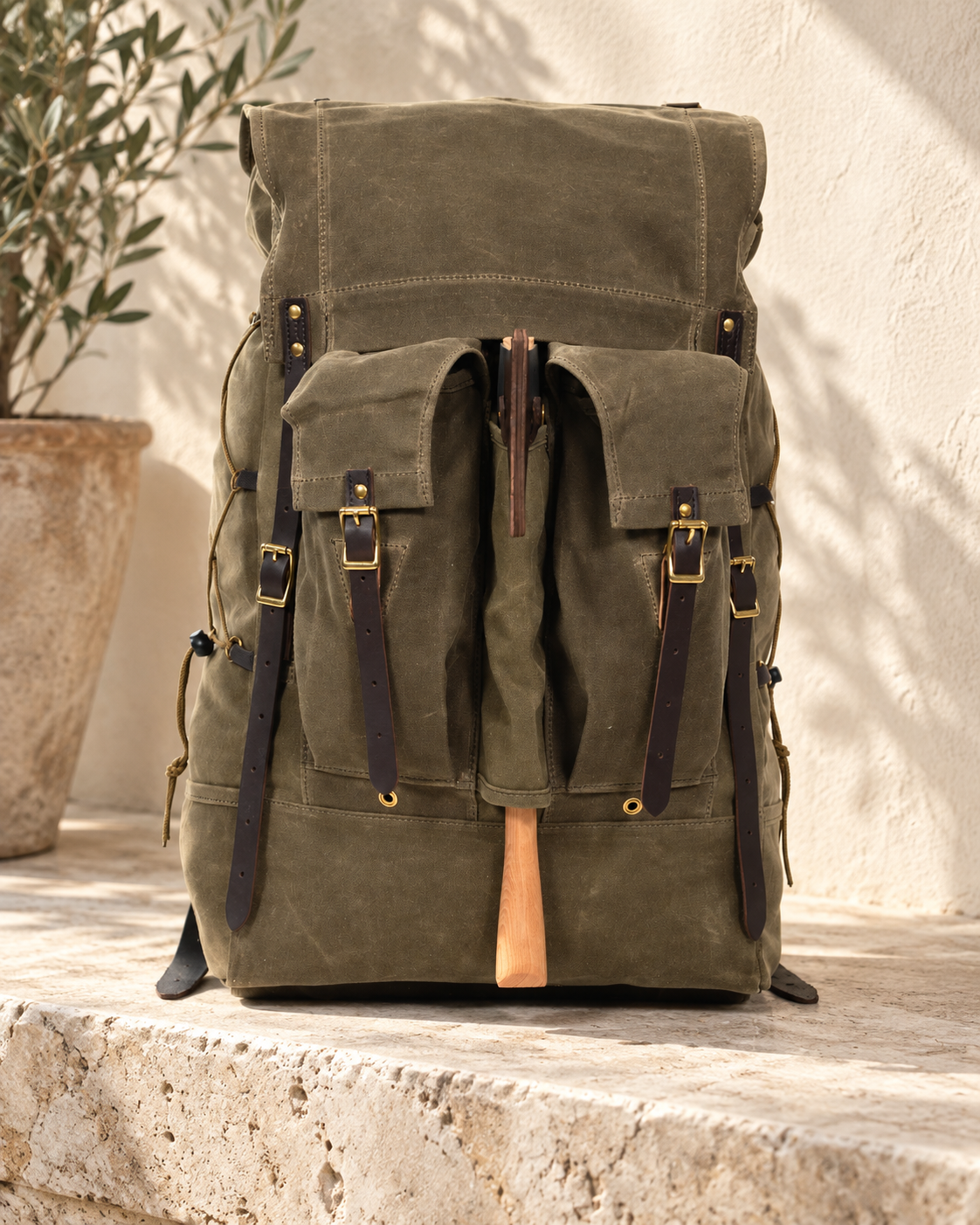 Illustrative textile-body buckle backpack with a woven textile-look shell, leather-looking buckle straps and two projecting front flap pockets.