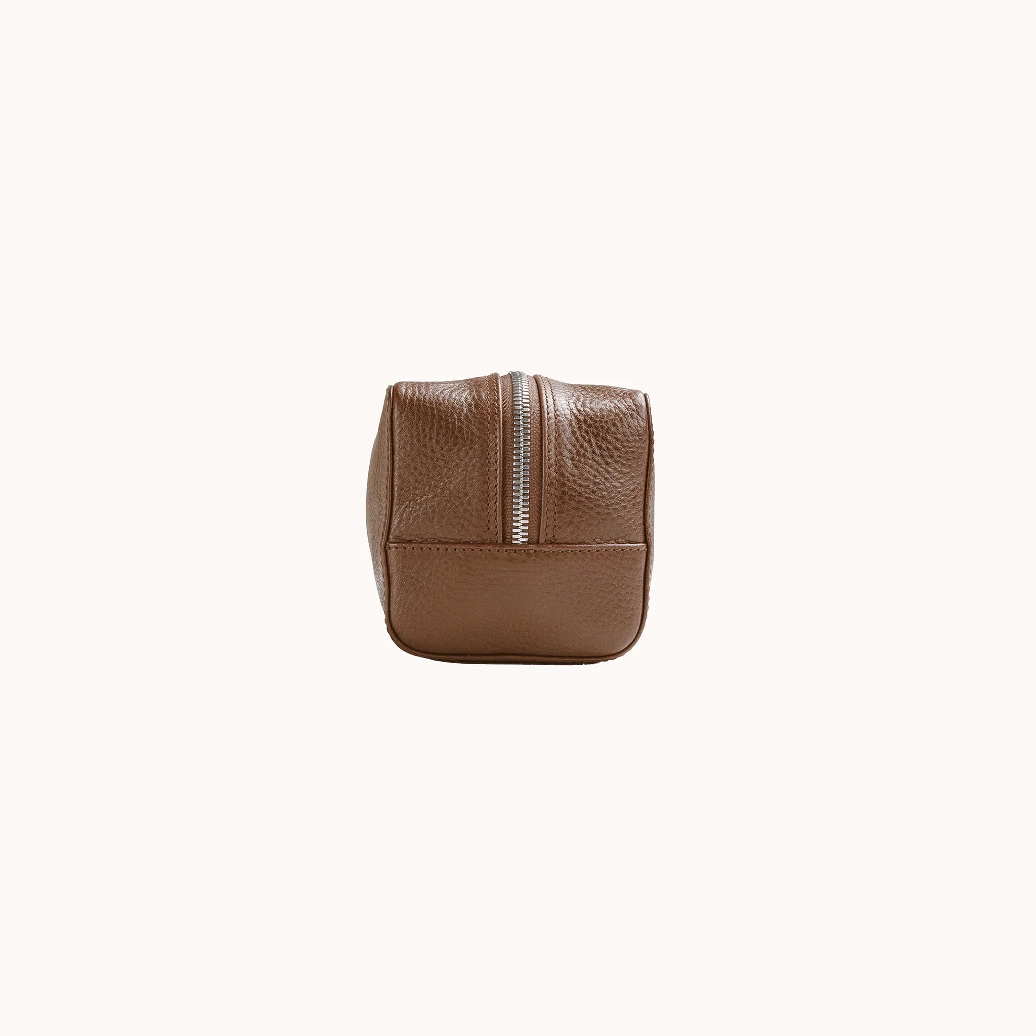 Lunburg Chamberlain Toiletry Bag in tumbled Heritage Amber leather, opposite side profile with seam and base.