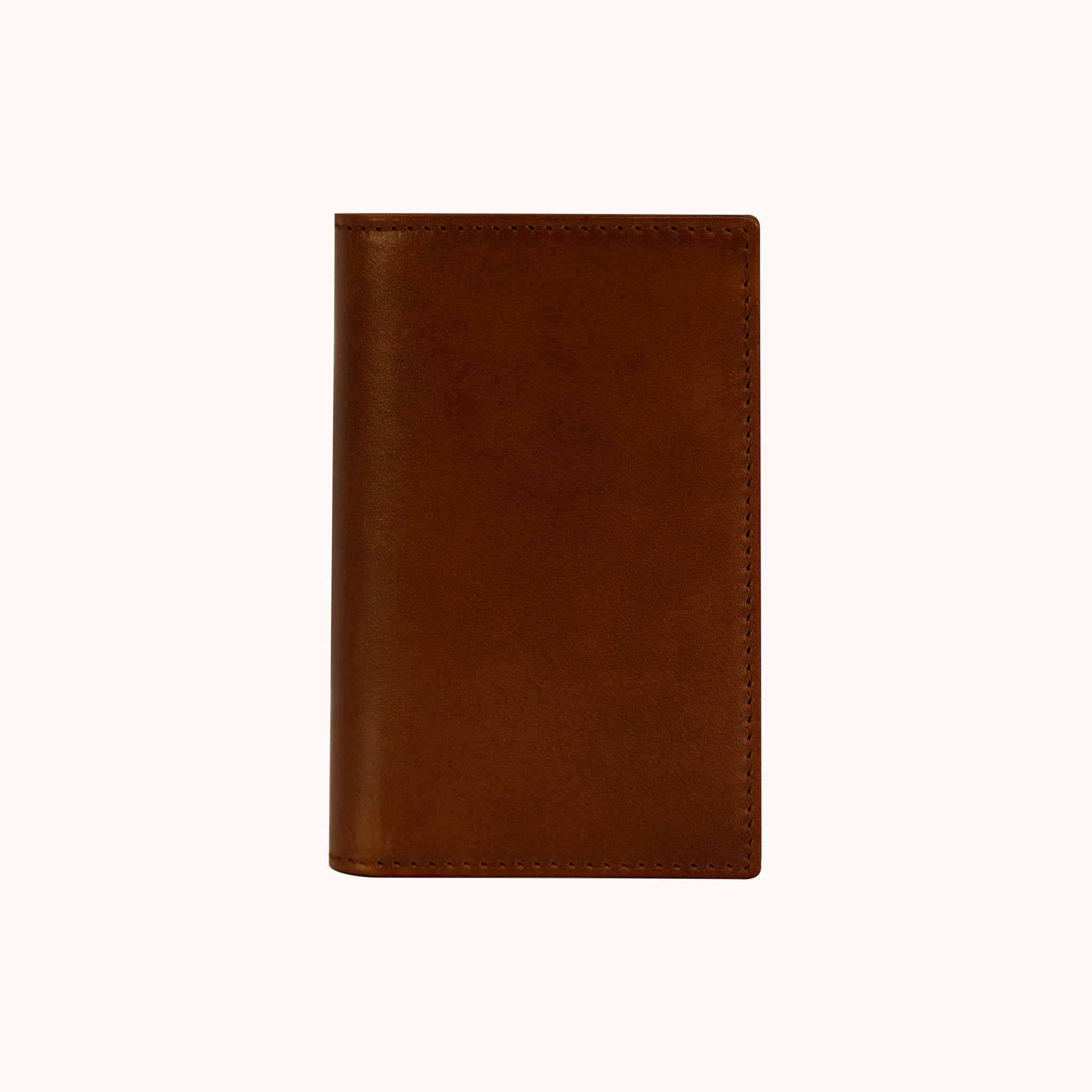 Lunburg Signet Vertical Bifold in Deep Mahogany, front view closed, showing the clean face of vegetable-tanned Perpetual Leather (from Tempesti) with folded edge construction and no visible raw edges.
