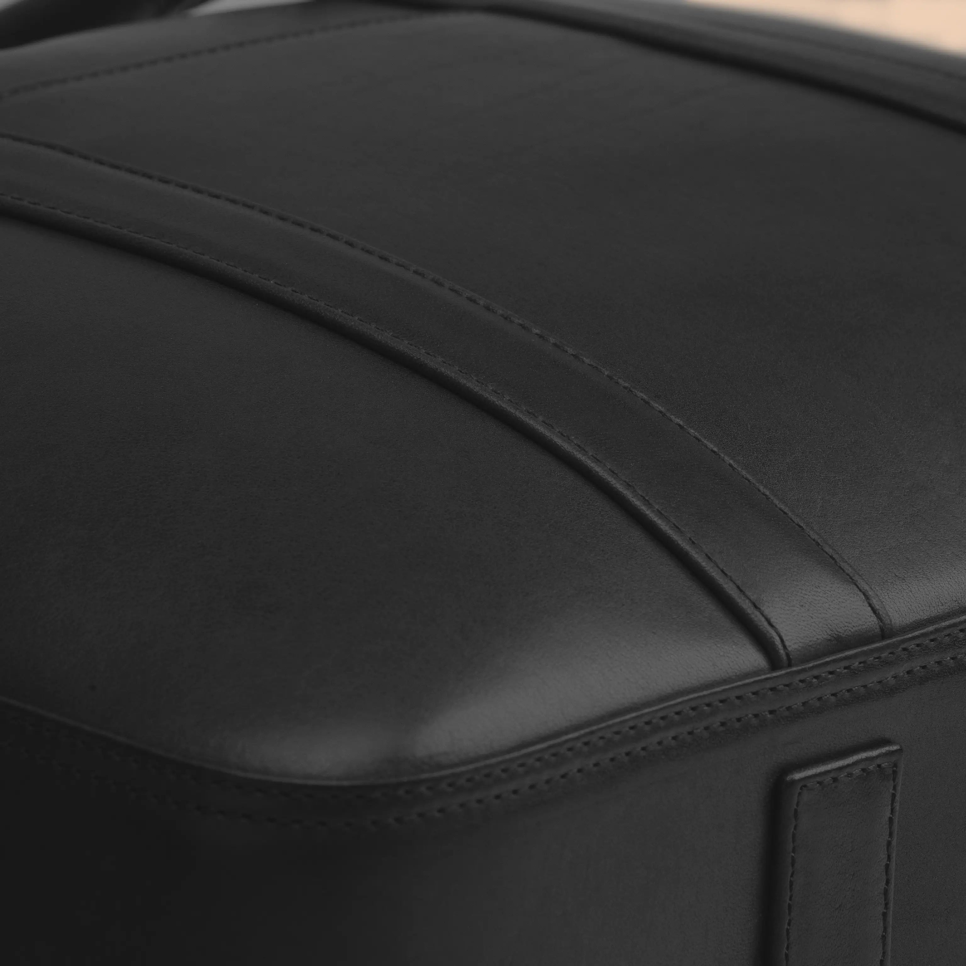Detail of the Lunburg Opus Briefcase in Burnt Timber showing the precision panel seam and folded edge construction in vegetable-tanned Perpetual Leather (from Tempesti), precision executed to 0.1 mm tolerance.