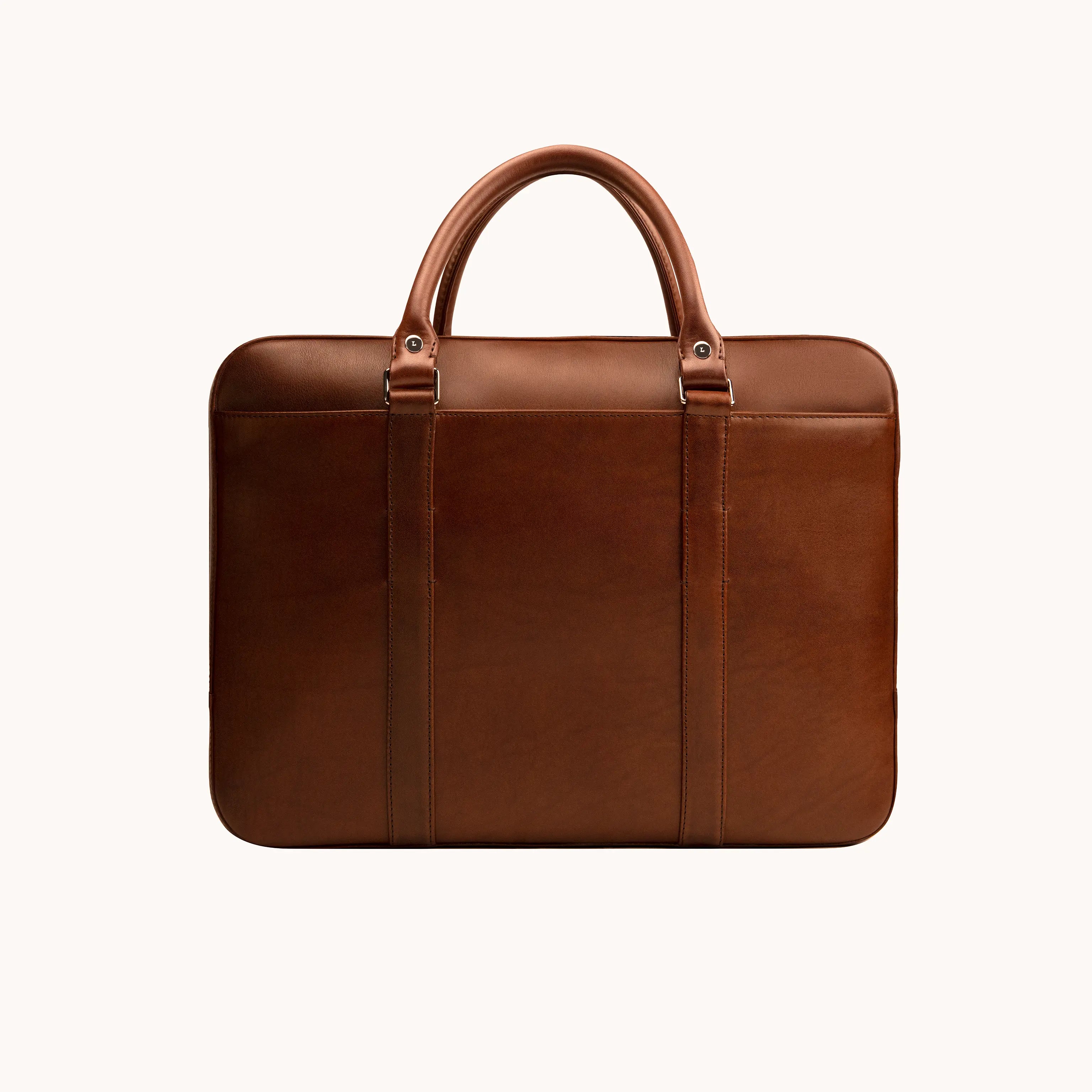 Lunburg Opus Briefcase in Deep Mahogany vegetable-tanned Perpetual Leather (from Tempesti), back view showing clean panel construction, folded leather handles, and 316L stainless steel studs.
