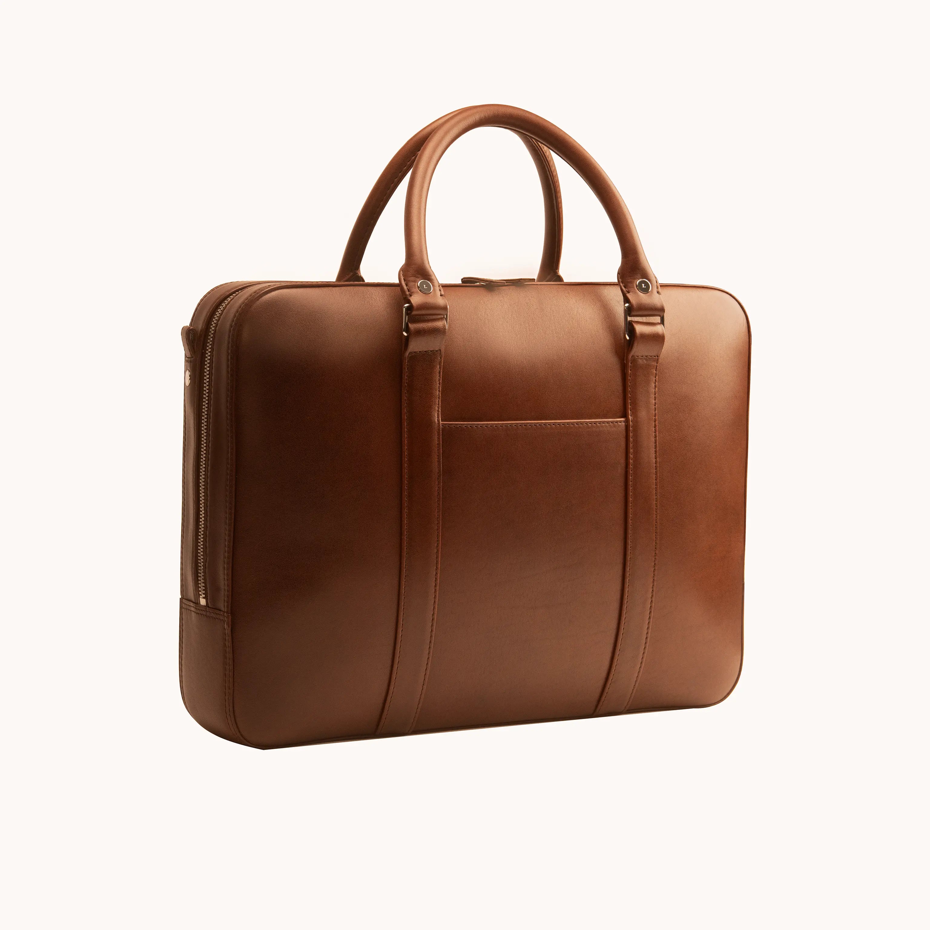 Lunburg Opus Briefcase in Deep Mahogany vegetable-tanned Perpetual Leather (from Tempesti), three-quarter view showing folded edge construction, exterior slip pocket, folded leather handles, and 316L stainless steel hardware.