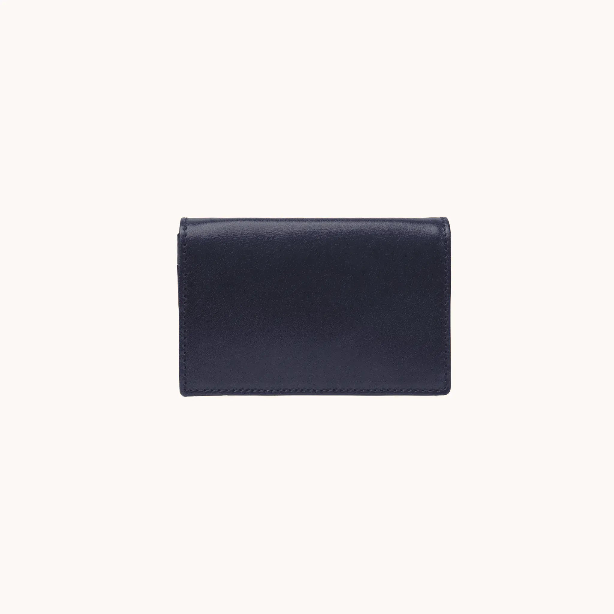 Lunburg Signet Business Card Wallet in Nocturnal Sapphire, front view closed, showing the flap closure and clean face of vegetable-tanned Perpetual Leather (from Tempesti) with folded edge construction and no visible raw edges.