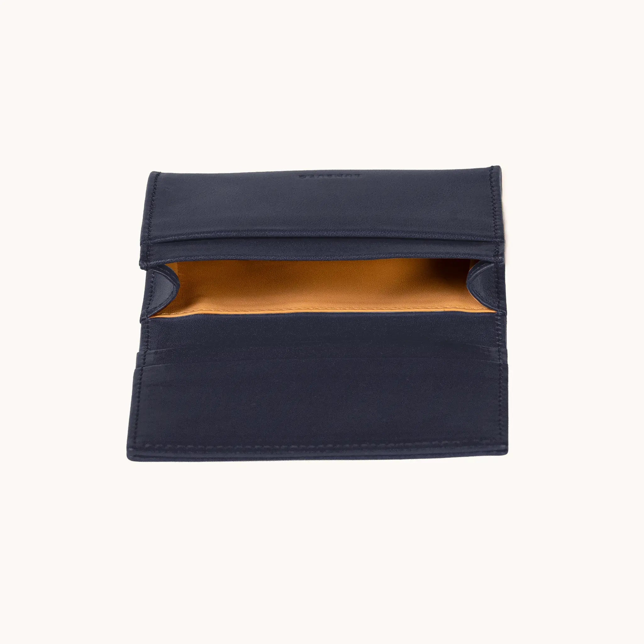 Lunburg Signet Business Card Wallet in Nocturnal Sapphire, interior profile view with flap lifted to reveal the goat leather lining of the central compartment and the card slot architecture, in vegetable-tanned Perpetual Leather (from Tempesti) with folded edge construction.