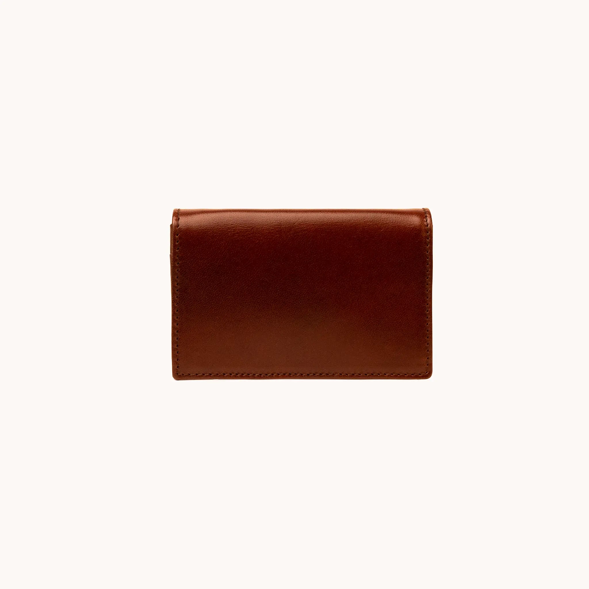 Lunburg Signet Business Card Wallet in Deep Mahogany, front view closed, showing the flap closure and clean face of vegetable-tanned Perpetual Leather (from Tempesti) with folded edge construction and no visible raw edges.