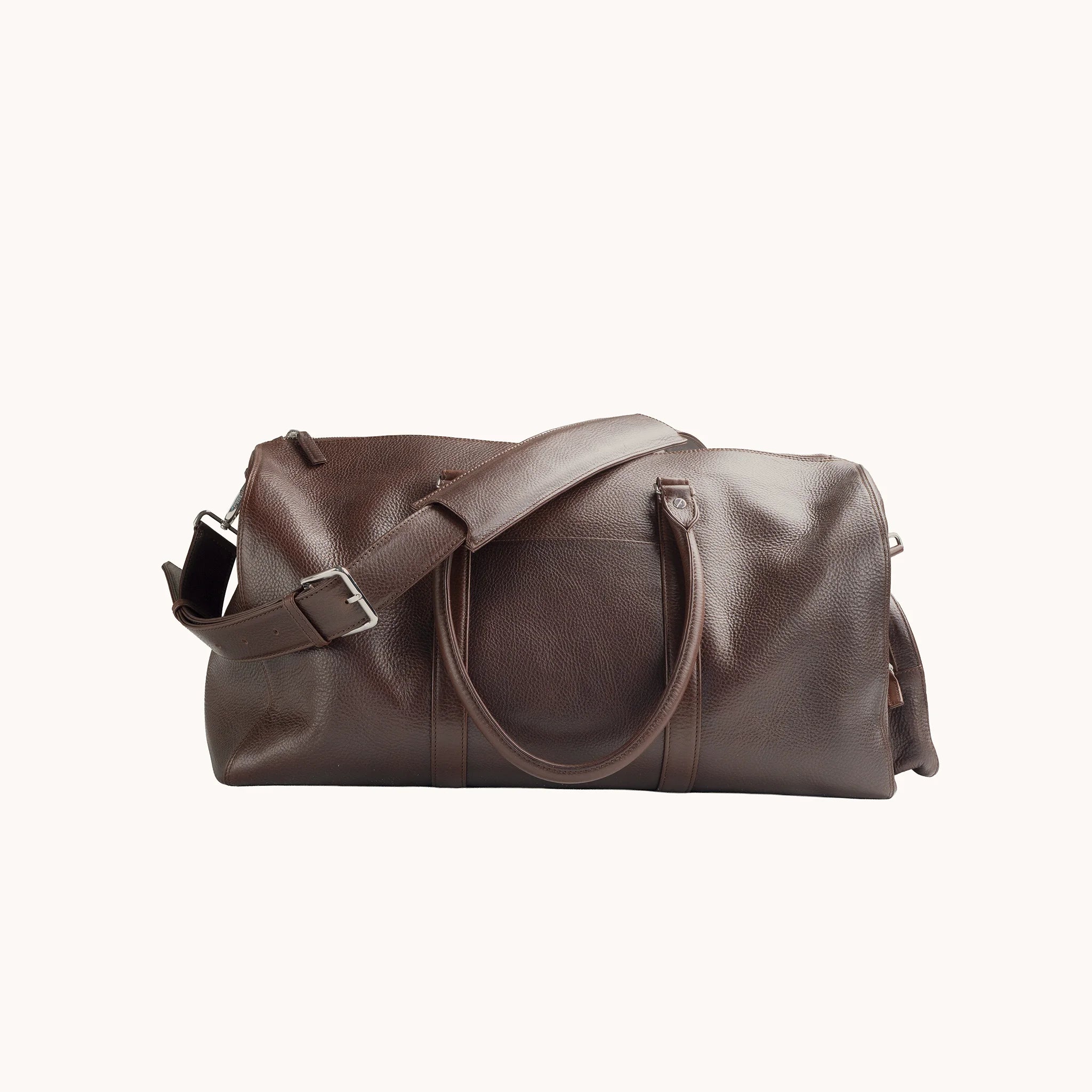 Estate Duffle Bag in Deep Mahogany, detail of the leather handle wrap, shoulder strap and belt-loop attachment.