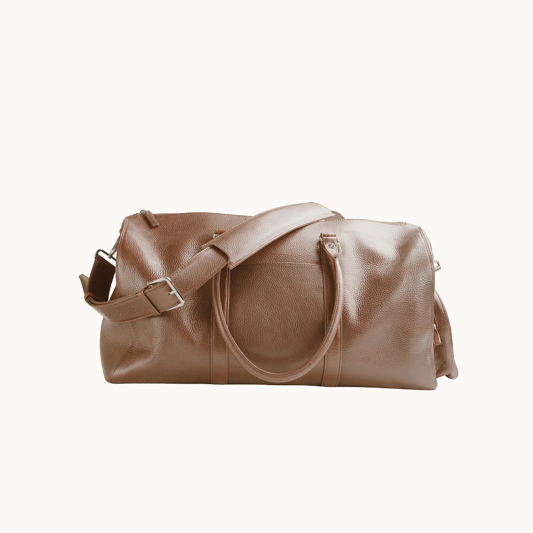 Estate Duffle Bag in Heritage Amber, detail of the leather handle wrap, shoulder strap and belt-loop attachment.