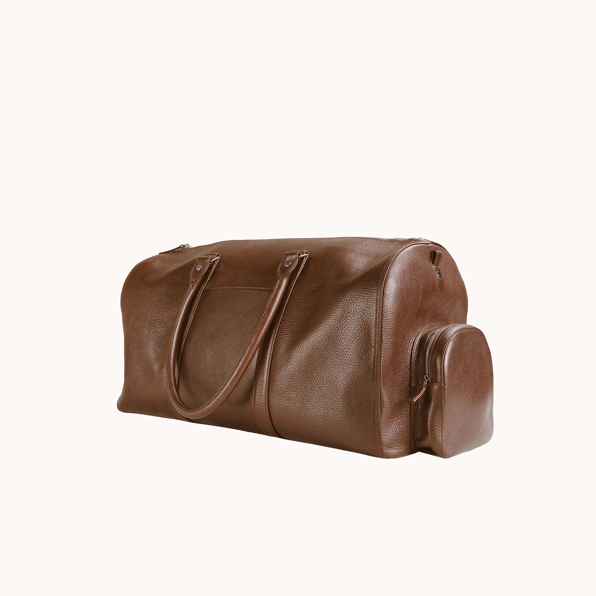 Lunburg Estate Duffle Bag in tumbled Heritage Amber leather, three-quarter view showing depth and handle drop.