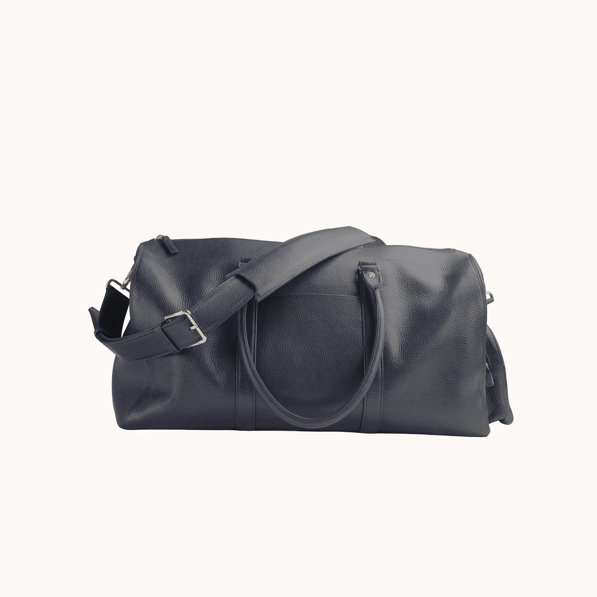 Estate Duffle Bag in Nocturnal Sapphire, detail of the leather handle wrap, shoulder strap and belt-loop attachment.