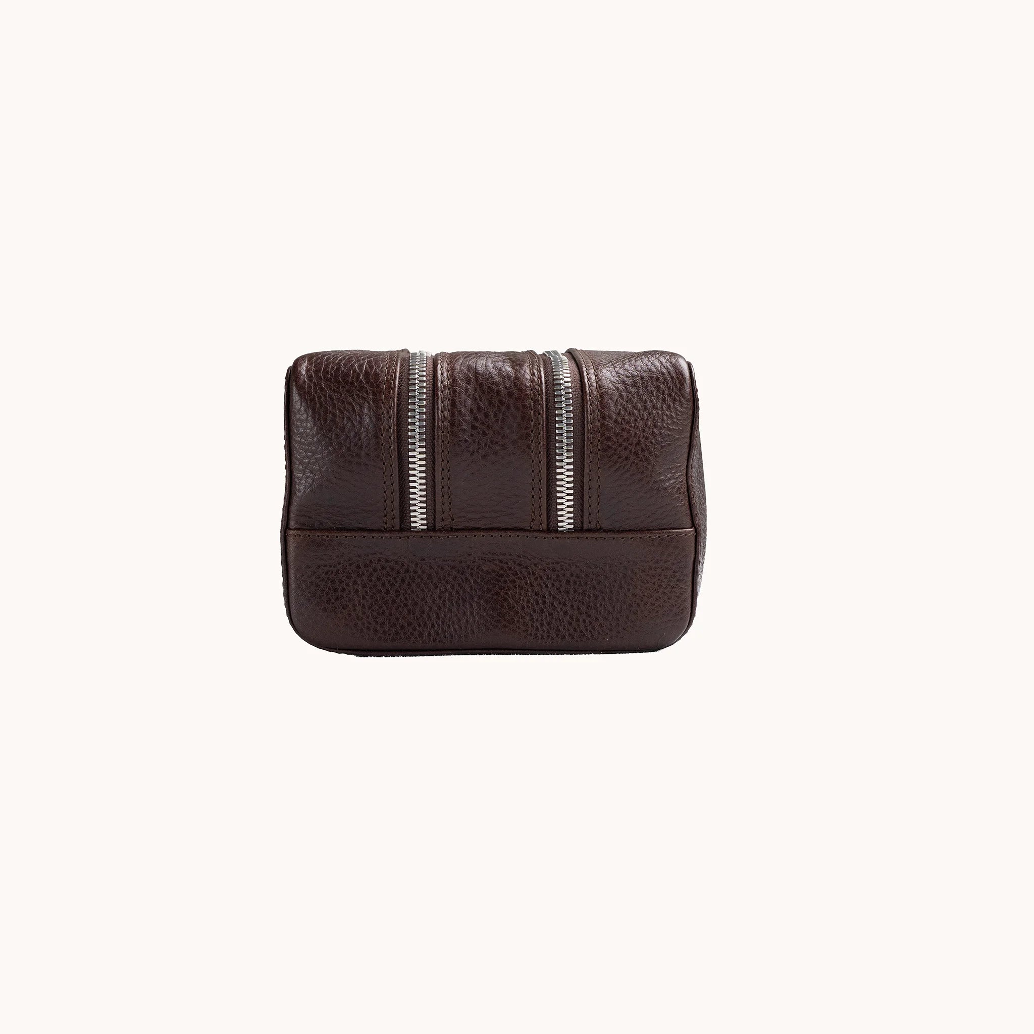 Lunburg Chamberlain Grand Toiletry Bag in tumbled Deep Mahogany leather, opposite side profile with seam and base.