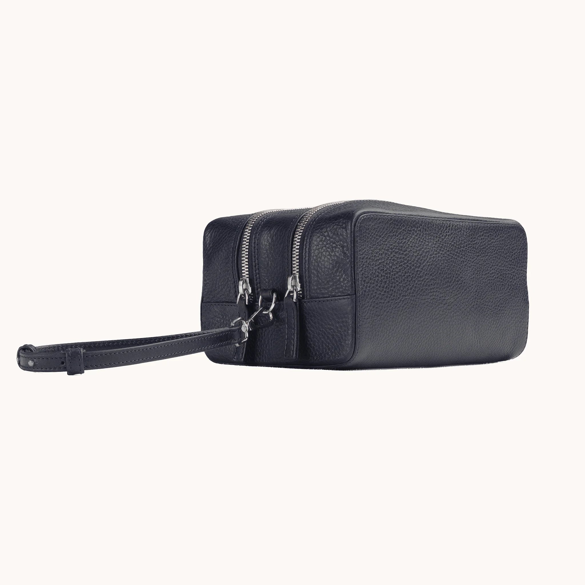 Lunburg Chamberlain Grand Toiletry Bag in tumbled Nocturnal Sapphire leather, three-quarter view showing depth and zip line.