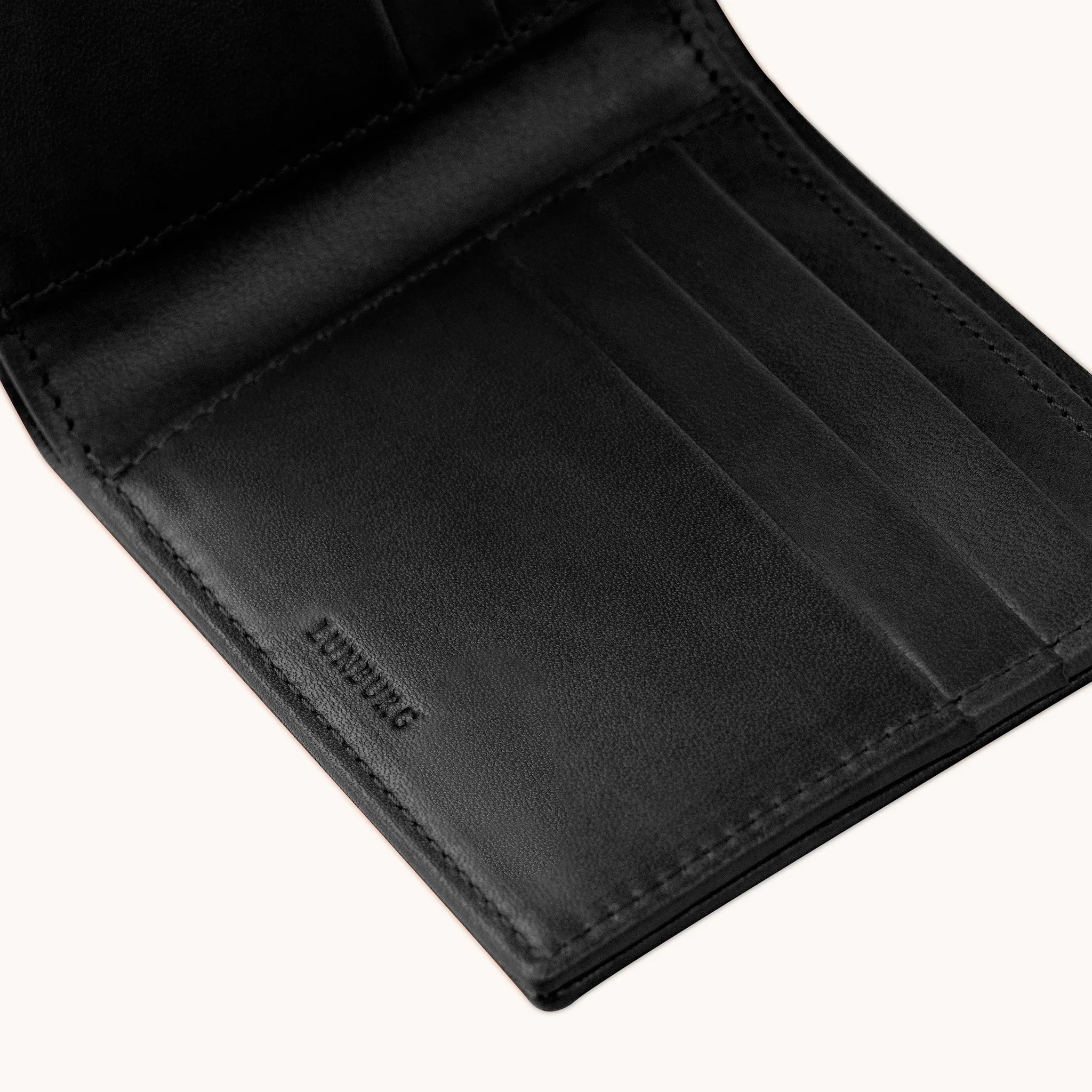 Lunburg Signet Horizontal Bifold in Burnt Timber, angled interior detail showing the card slot layering, heat-embossed Lunburg mark, and goat leather lining with folded edge construction throughout, in vegetable-tanned Perpetual Leather (from Tempesti).