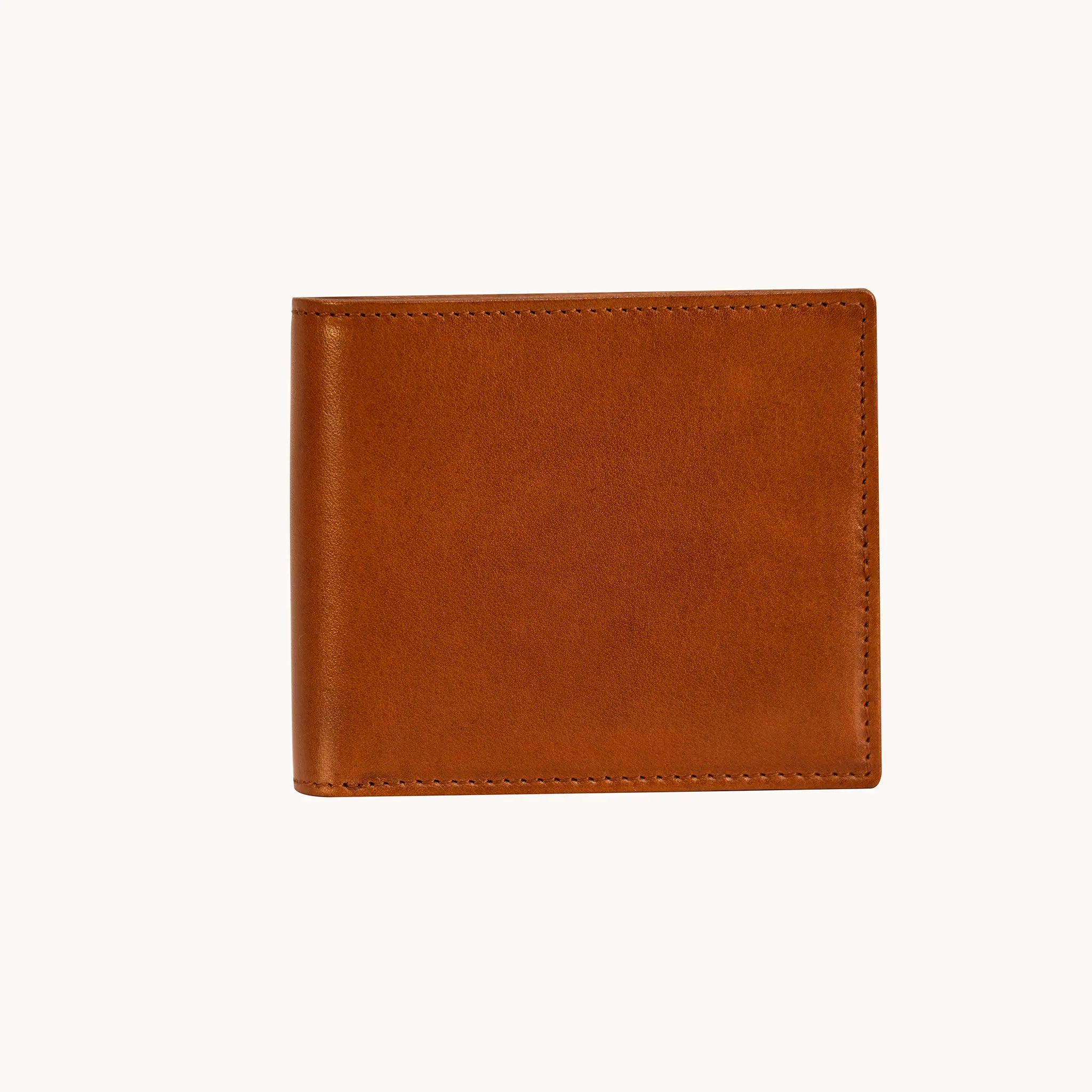 Lunburg Horizontal Signet Bifold Wallet in Heritage Amber, closed front view showing the uninterrupted leather surface, folded edge construction, natural color variation, and perimeter stitching in vegetable-tanned Perpetual Leather.