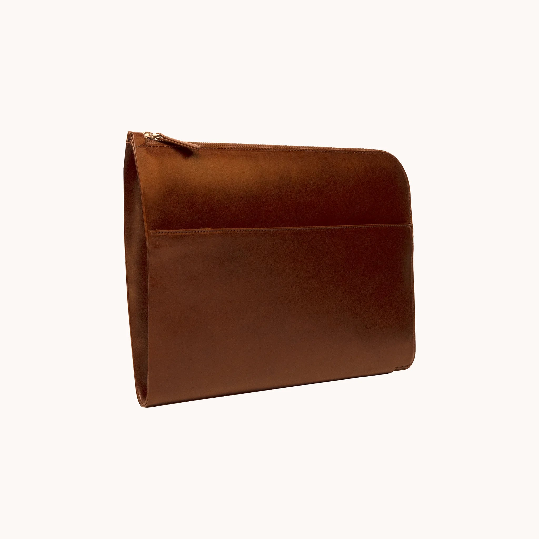 Lunburg Memoir Laptop Sleeve in Deep Mahogany, three-quarter back view showing the exterior slip pocket, top YKK Excella zipper with leather pull, and slim profile, in vegetable-tanned Perpetual Leather (from Tempesti) with folded edge construction.