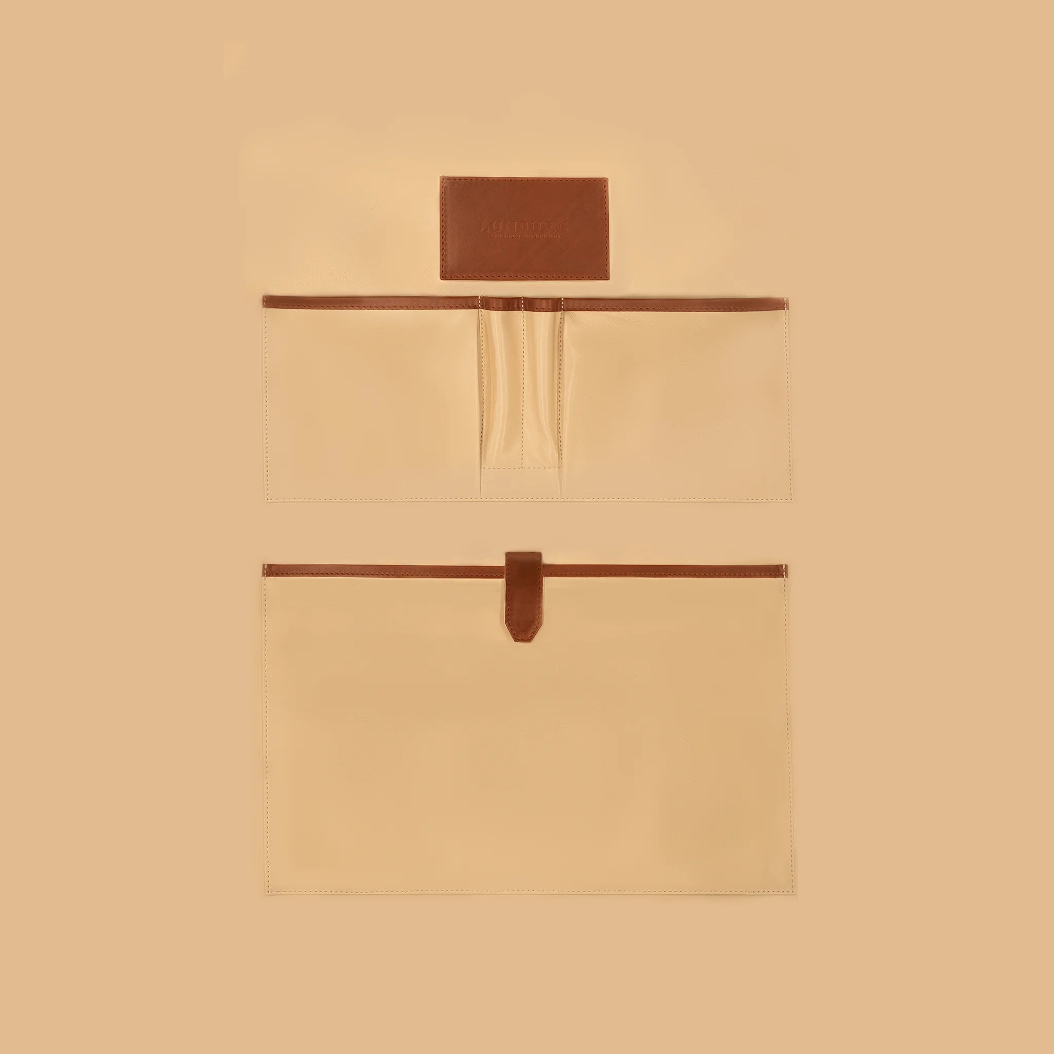 Lunburg Opus Briefcase Essential interior vertical layout in Heritage Amber, high-contrast goat leather lining with heat-embossed Lunburg card holder, two pen holders, one large laptop compartment, and two large open pockets for documents and accessories, with Heritage Amber Perpetual Leather (from Tempesti) trim and leather strap closure.