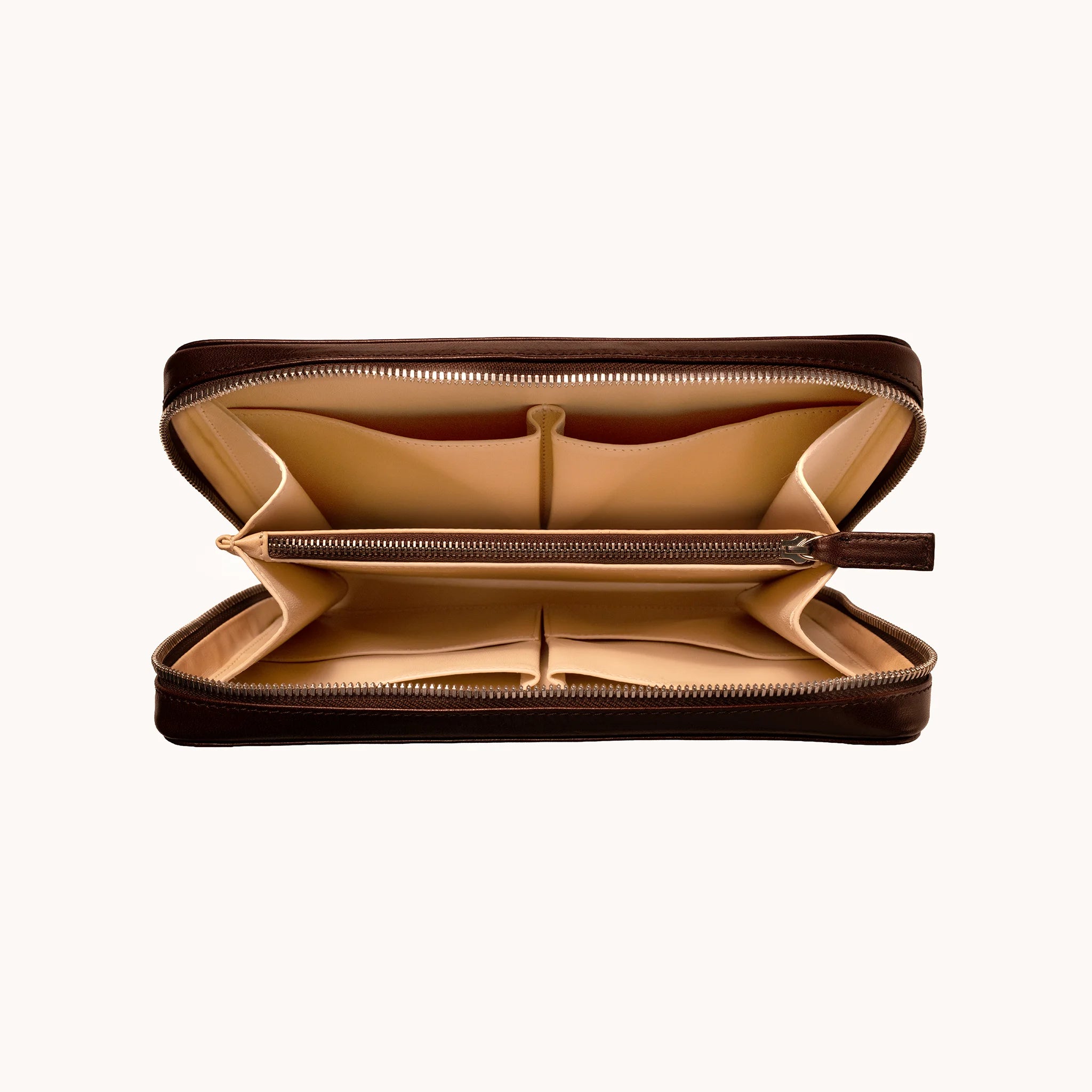 Lunburg Memoir Organiser in Deep Mahogany, open interior view showing the goat leather lining with multiple compartments, an internal YKK Excella zipped pocket, and open pockets for cables and accessories, in vegetable-tanned Perpetual Leather (from Tempesti) with folded edge construction throughout.