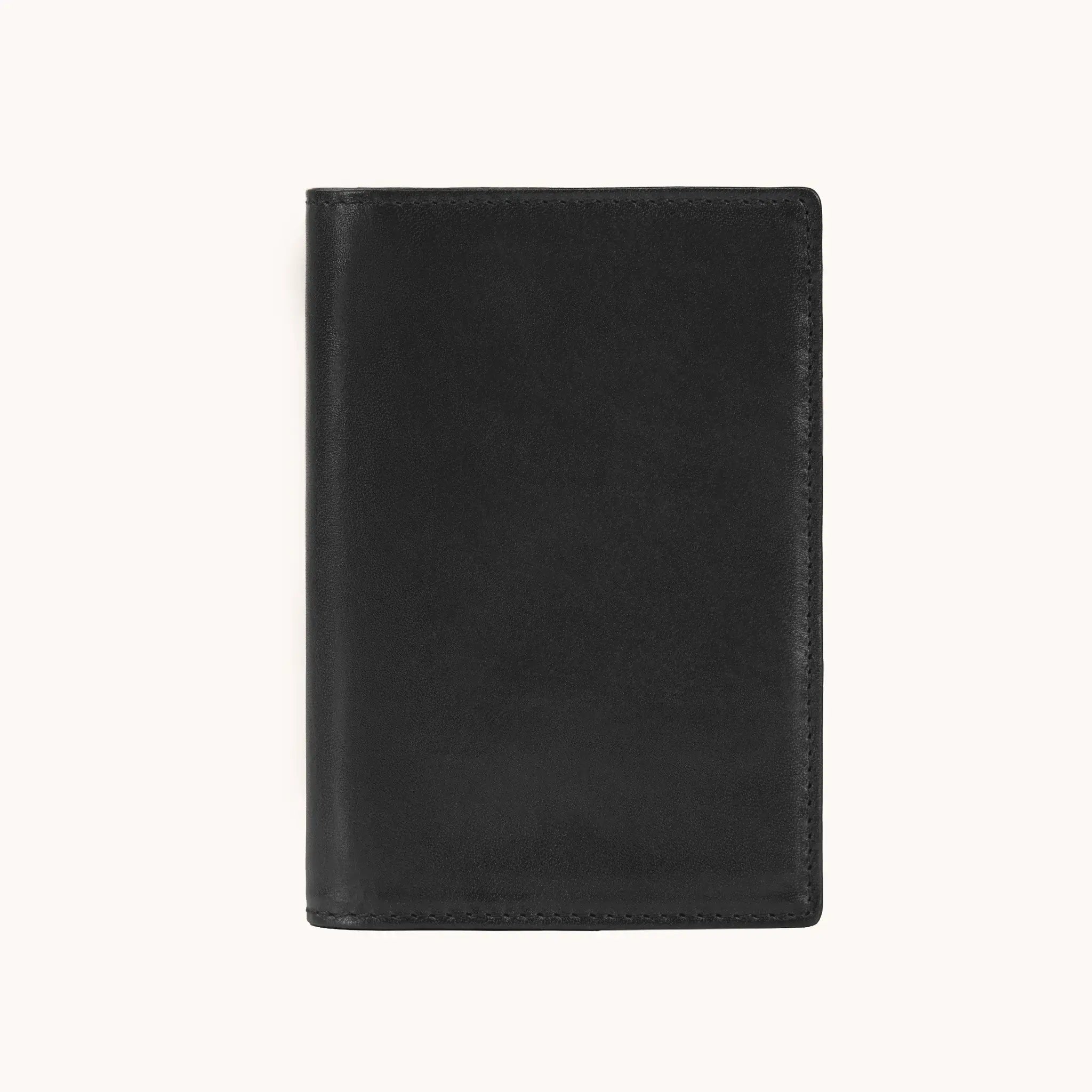 Lunburg Signet Passport Folio in Burnt Timber, front view closed, showing the clean face of vegetable-tanned Perpetual Leather (from Tempesti) with folded edge construction and no visible raw edges.