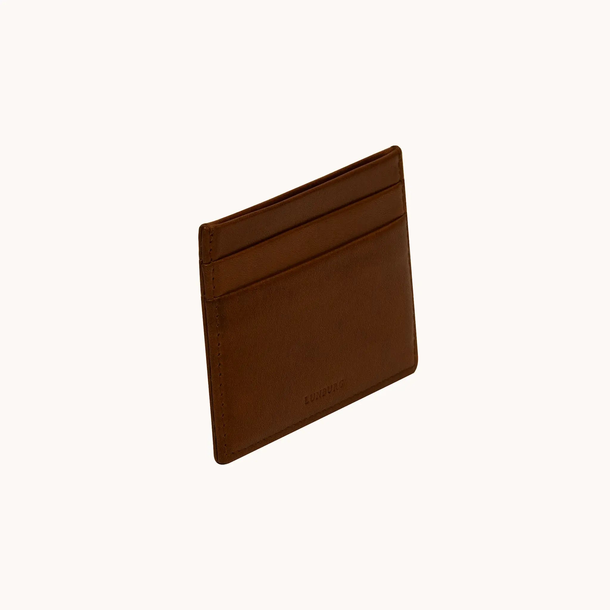 Lunburg Signet Card Holder in Deep Mahogany, three-quarter view showing the card slots and heat-embossed Lunburg mark, in vegetable-tanned Perpetual Leather (from Tempesti) with folded edge construction.