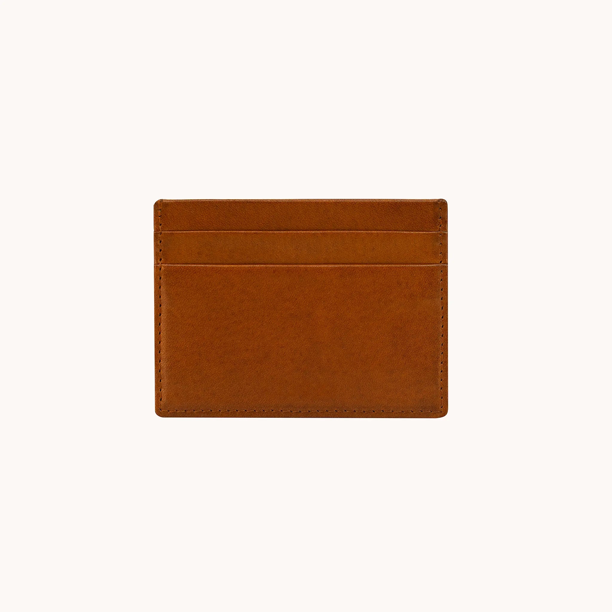 Lunburg Signet Card Holder in Heritage Amber, back view showing card slots, folded edge construction, natural color variation, and perimeter stitching in vegetable-tanned Perpetual Leather.