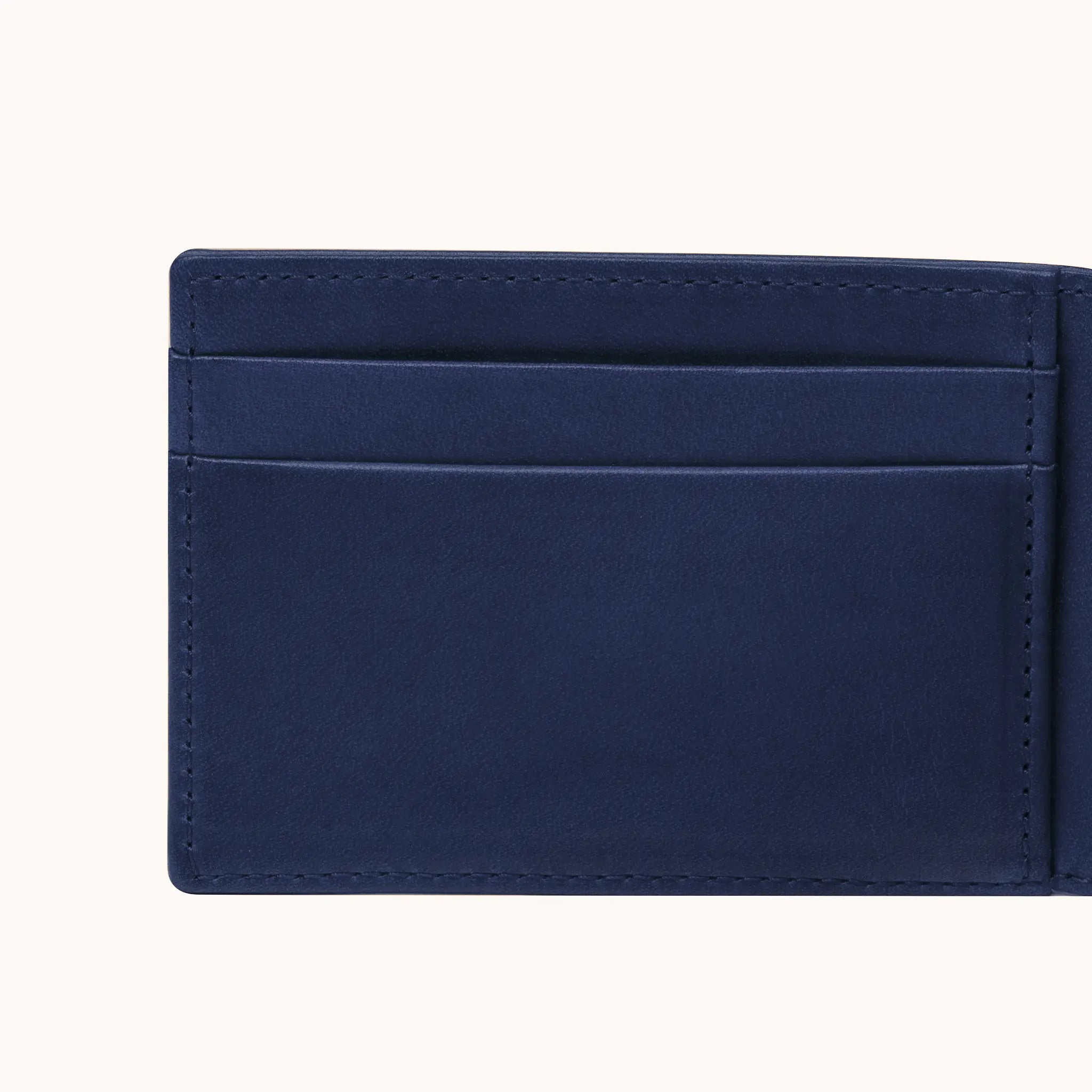 Lunburg Signet Small Horizontal in Nocturnal Sapphire, close-up detail of the interior card slot layering and large open pocket showing the folded edge construction of Rempliage on each pocket edge, in vegetable-tanned Perpetual Leather (from Tempesti).