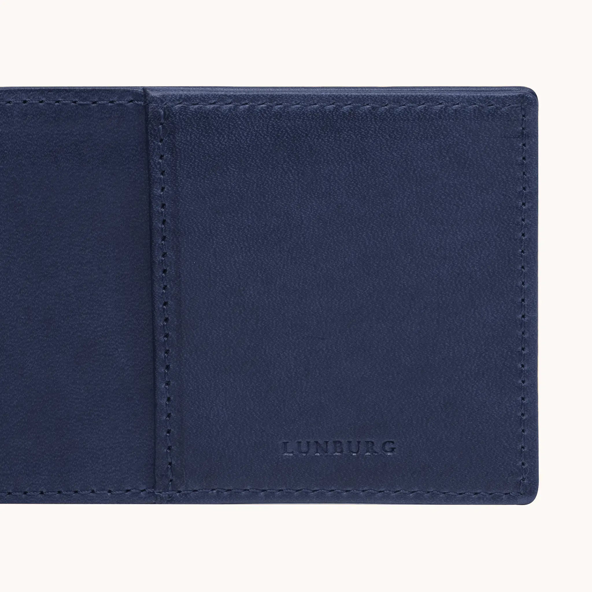 Lunburg Signet Small Horizontal in Nocturnal Sapphire, detail view of the interior right panel showing the heat-embossed Lunburg mark beside the card slot partition, in vegetable-tanned Perpetual Leather (from Tempesti) with folded edge construction throughout.