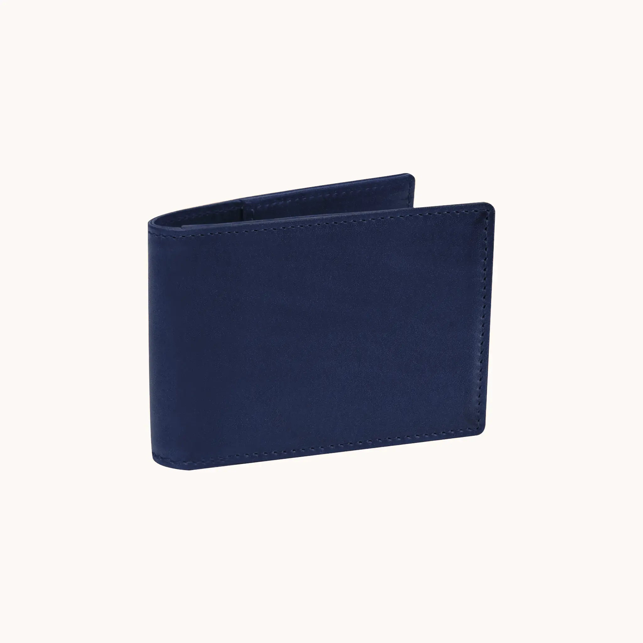 Lunburg Signet Small Horizontal in Nocturnal Sapphire, three-quarter view slightly open showing the exterior grain, spine, and a glimpse of the interior, in vegetable-tanned Perpetual Leather (from Tempesti) with folded edge construction.