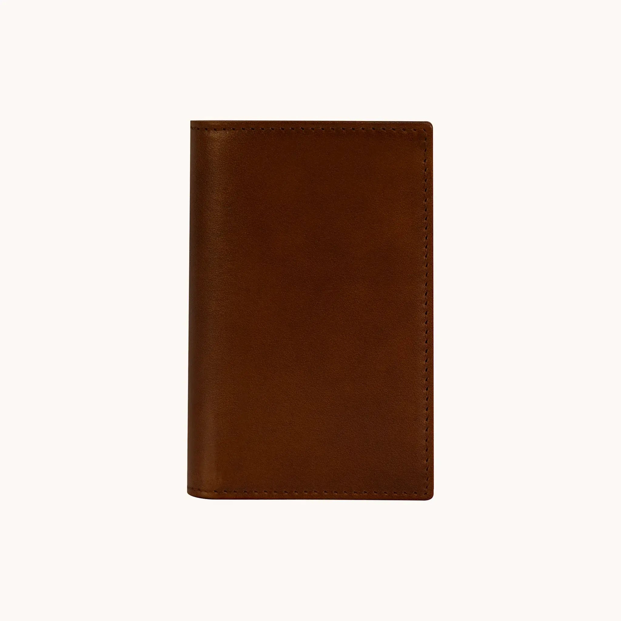 Lunburg Signet Small Vertical in Deep Mahogany, front view closed, showing the clean face of vegetable-tanned Perpetual Leather (from Tempesti) with folded edge construction and no visible raw edges.