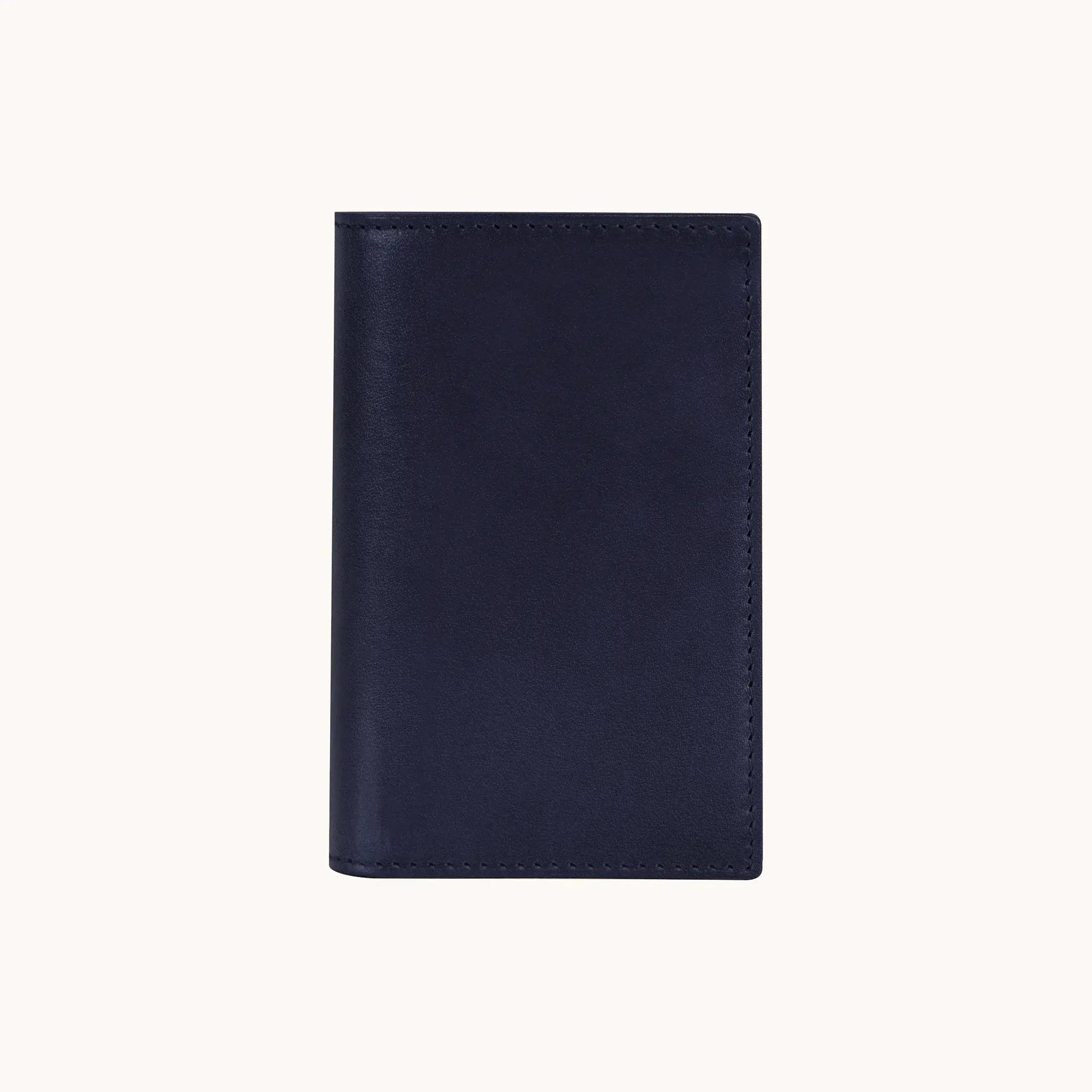 Lunburg Signet Small Vertical in Nocturnal Sapphire, front view closed, showing the clean face of vegetable-tanned Perpetual Leather (from Tempesti) with folded edge construction and no visible raw edges.