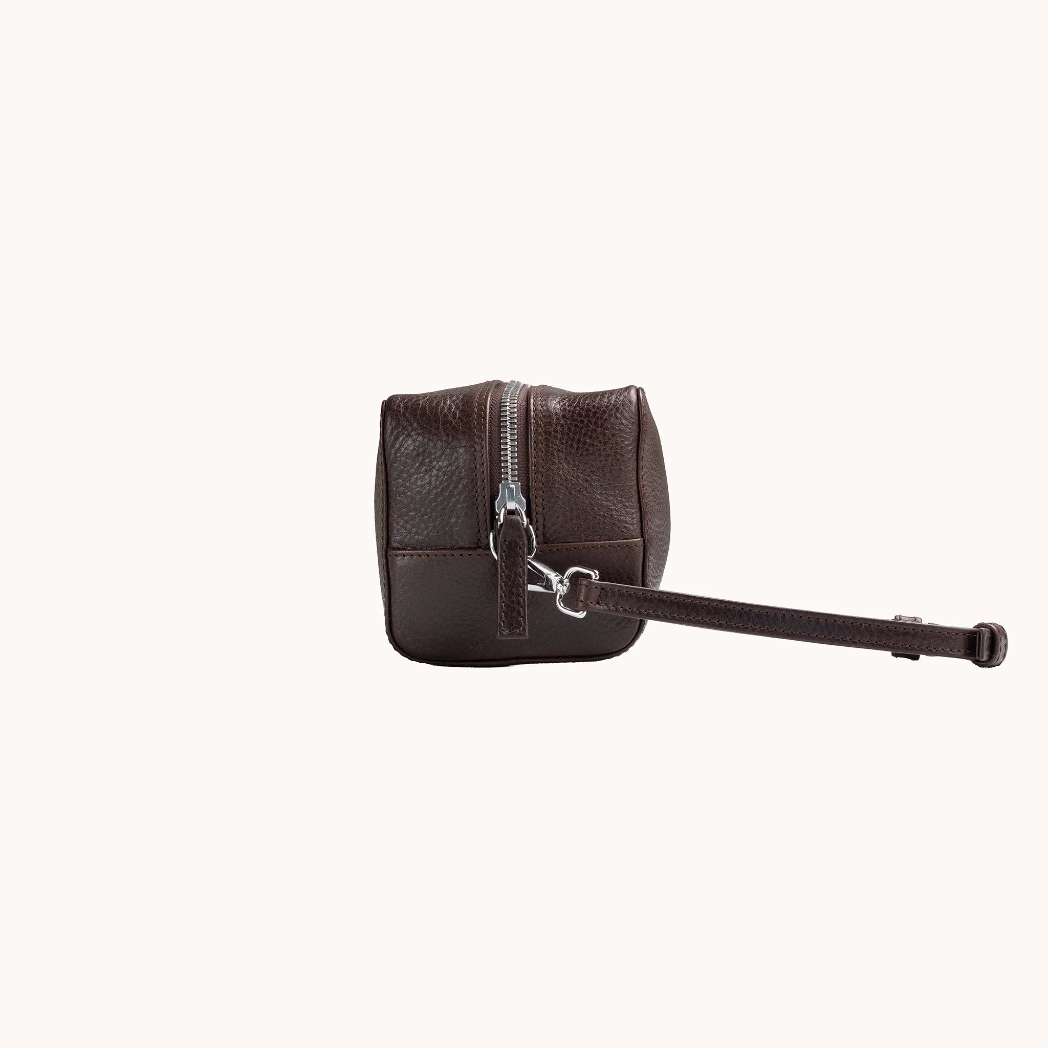 Lunburg Chamberlain Toiletry Bag in tumbled Deep Mahogany leather, side profile with carrying handle visible.