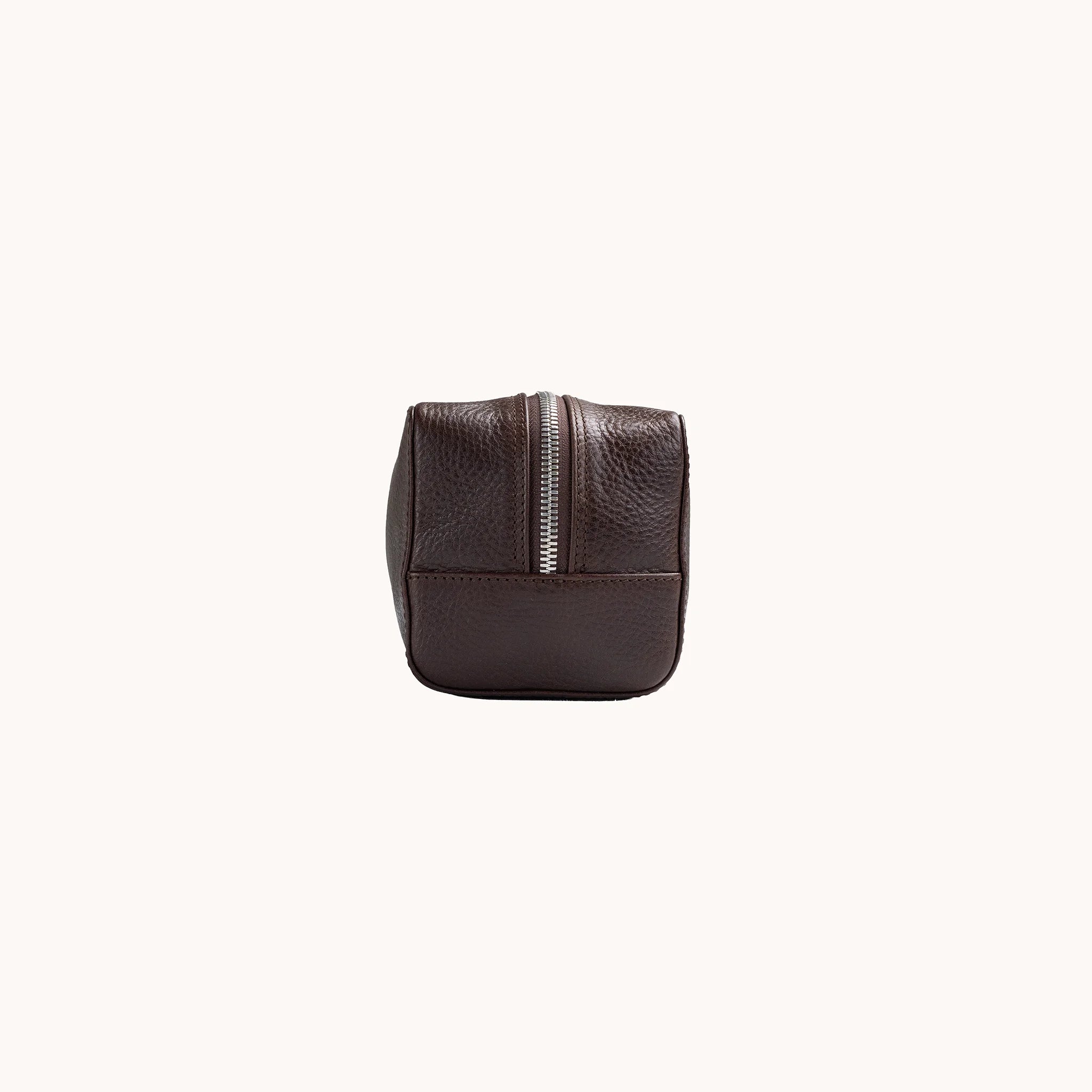Lunburg Chamberlain Toiletry Bag in tumbled Deep Mahogany leather, opposite side profile with seam and base.