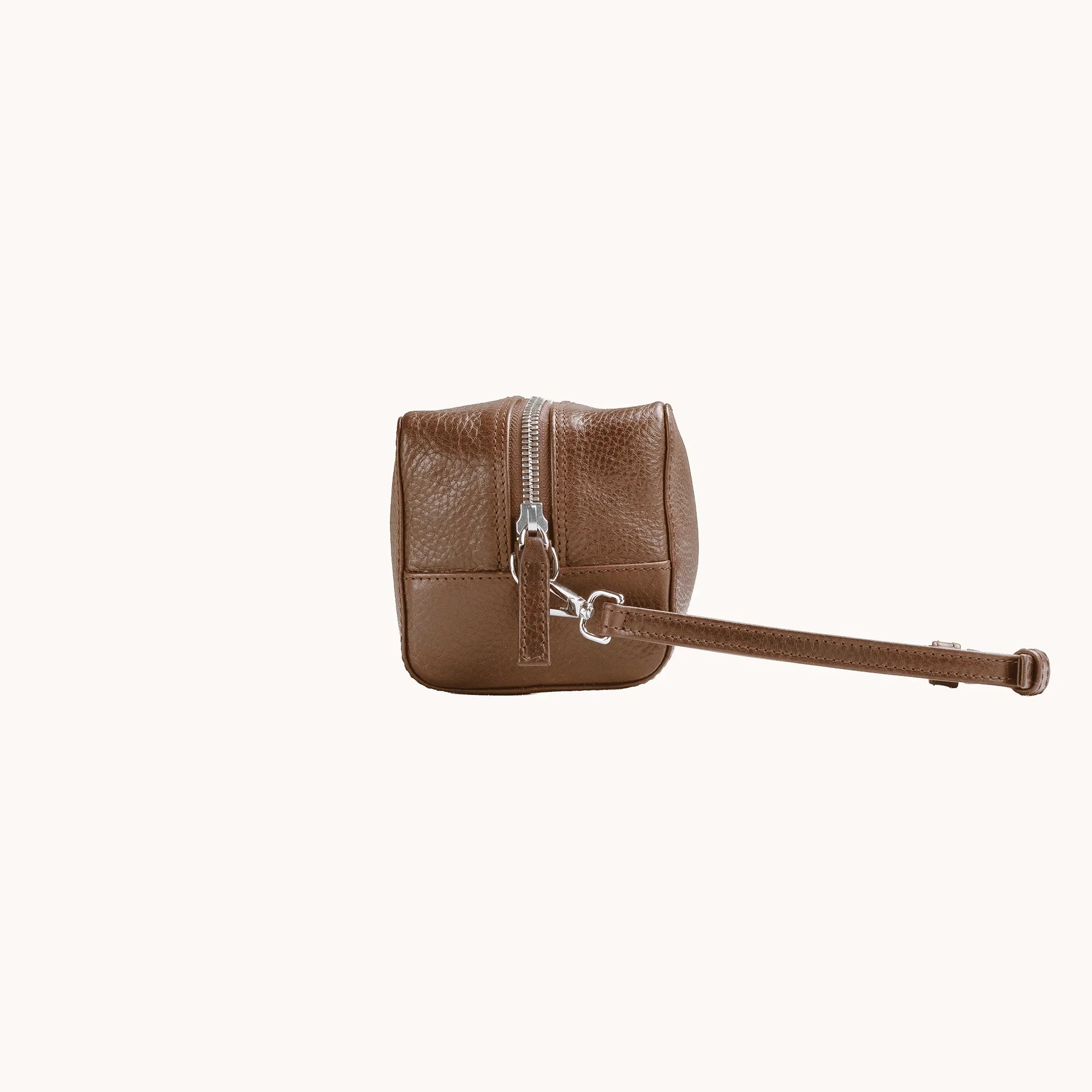 Lunburg Chamberlain Toiletry Bag in tumbled Heritage Amber leather, side profile with carrying handle visible.