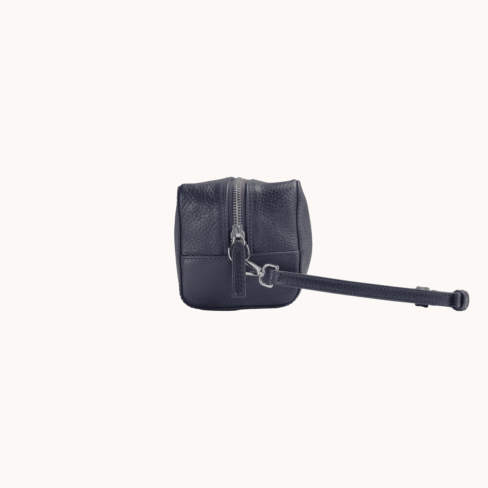 Lunburg Chamberlain Toiletry Bag in tumbled Nocturnal Sapphire leather, side profile with carrying handle visible.