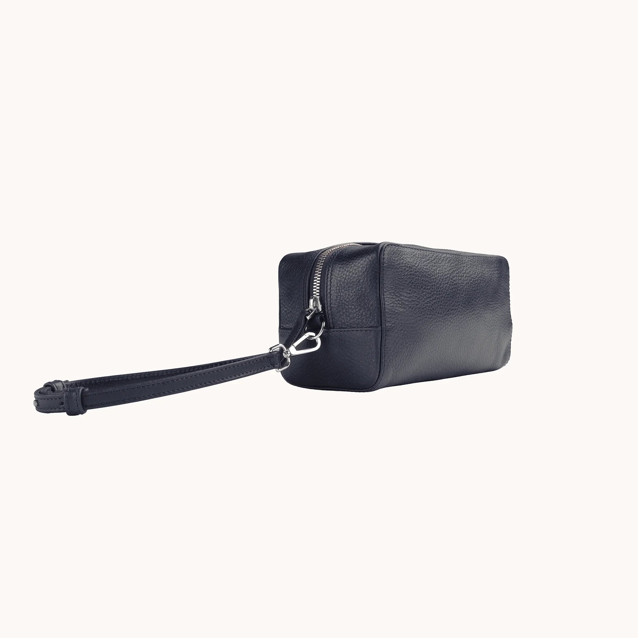 Lunburg Chamberlain Toiletry Bag in tumbled Nocturnal Sapphire leather, three-quarter view showing depth and zip line.